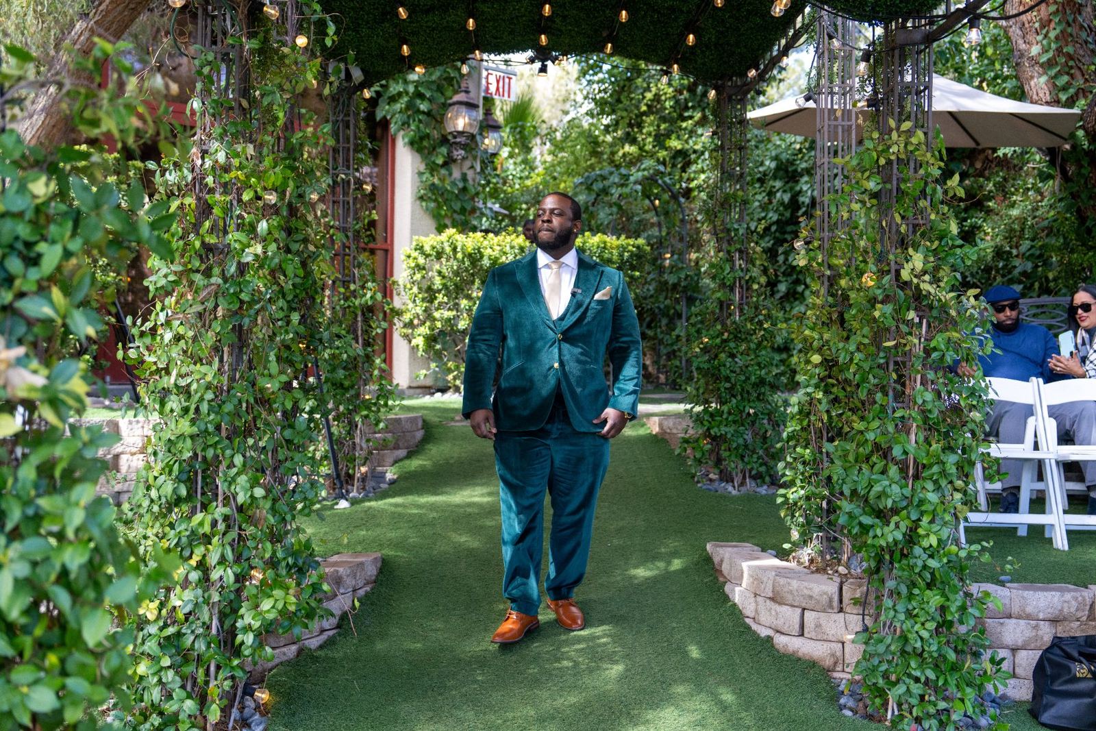 Las Vegas wedding photography — groom walking the garden aisle