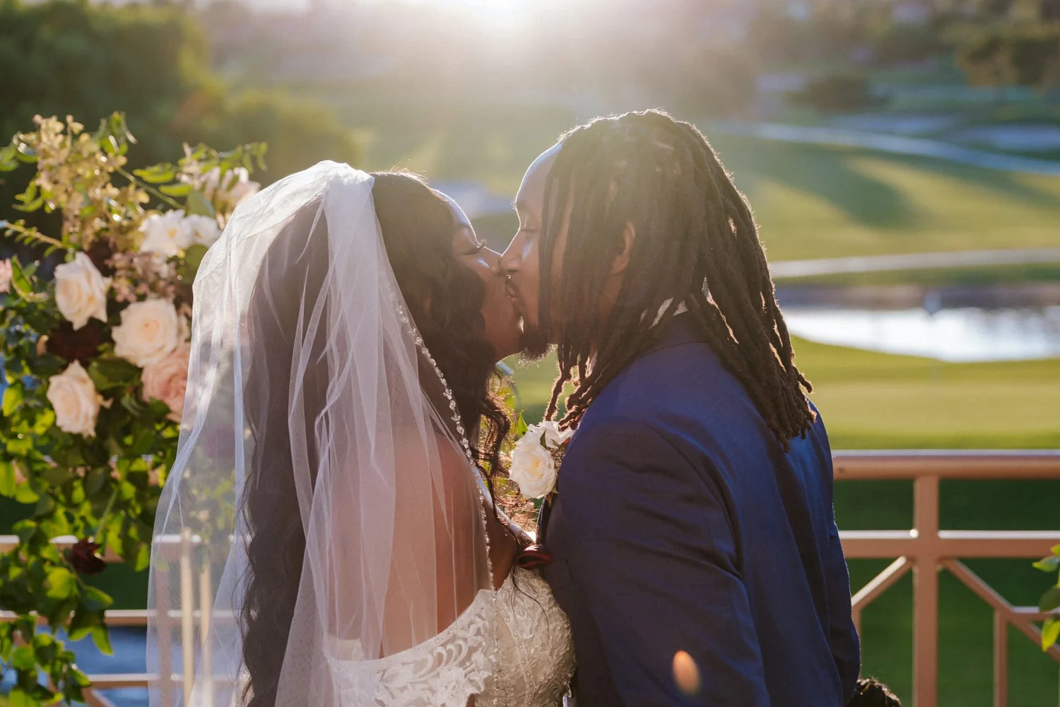 Las Vegas wedding photography — first kiss surrounded by floral decorations