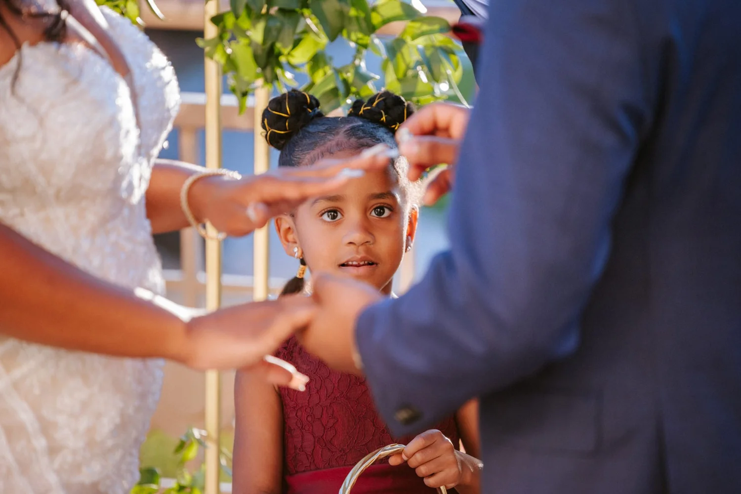 Las Vegas wedding photography — young girl in a red dress watching the ceremony