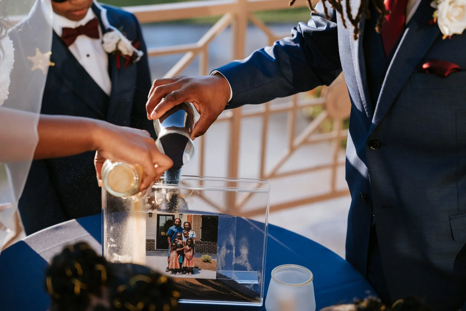 Las Vegas wedding photography — sand ceremony pouring into a glass box with a family photo