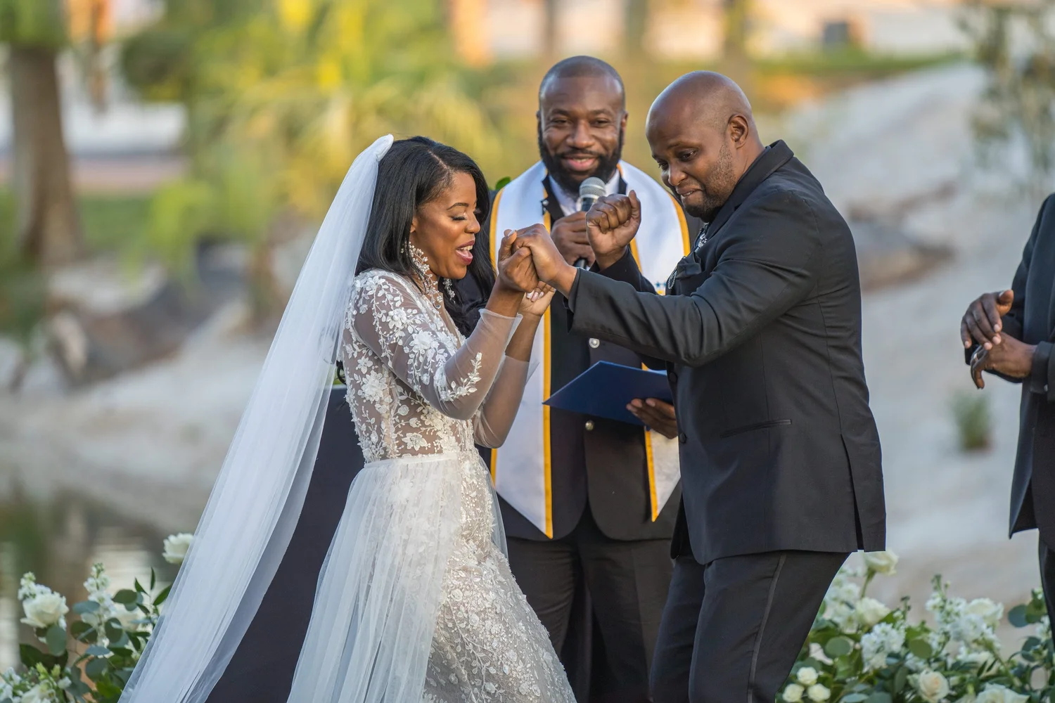 Las Vegas wedding photography — holding hands during the ceremony with the officiant behind
