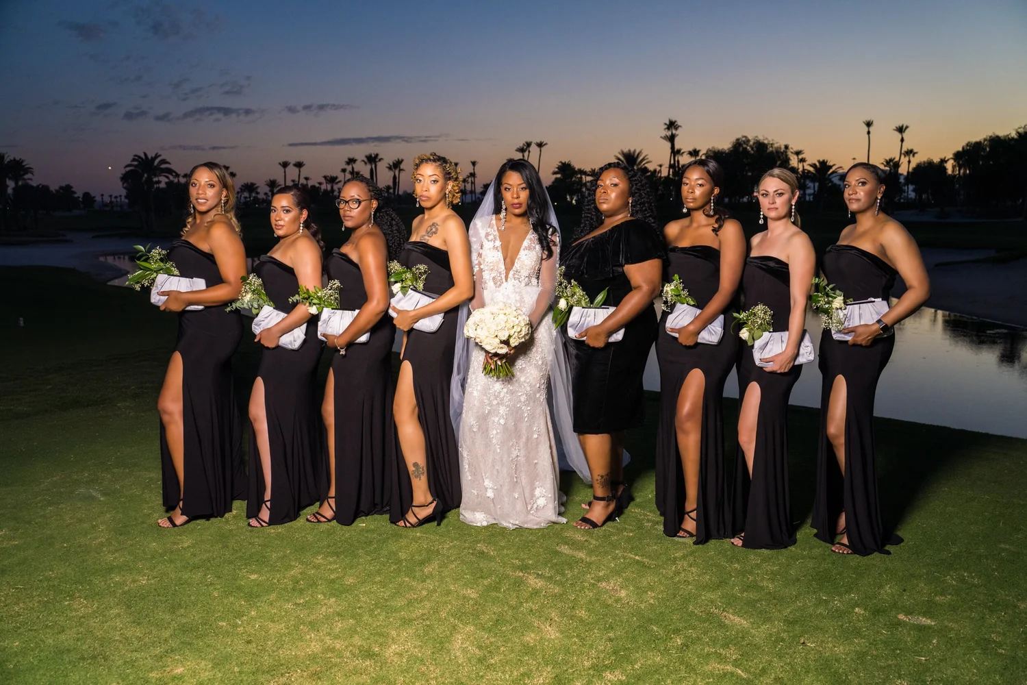 Las Vegas wedding photography — bride with nine bridesmaids at dusk under palm trees