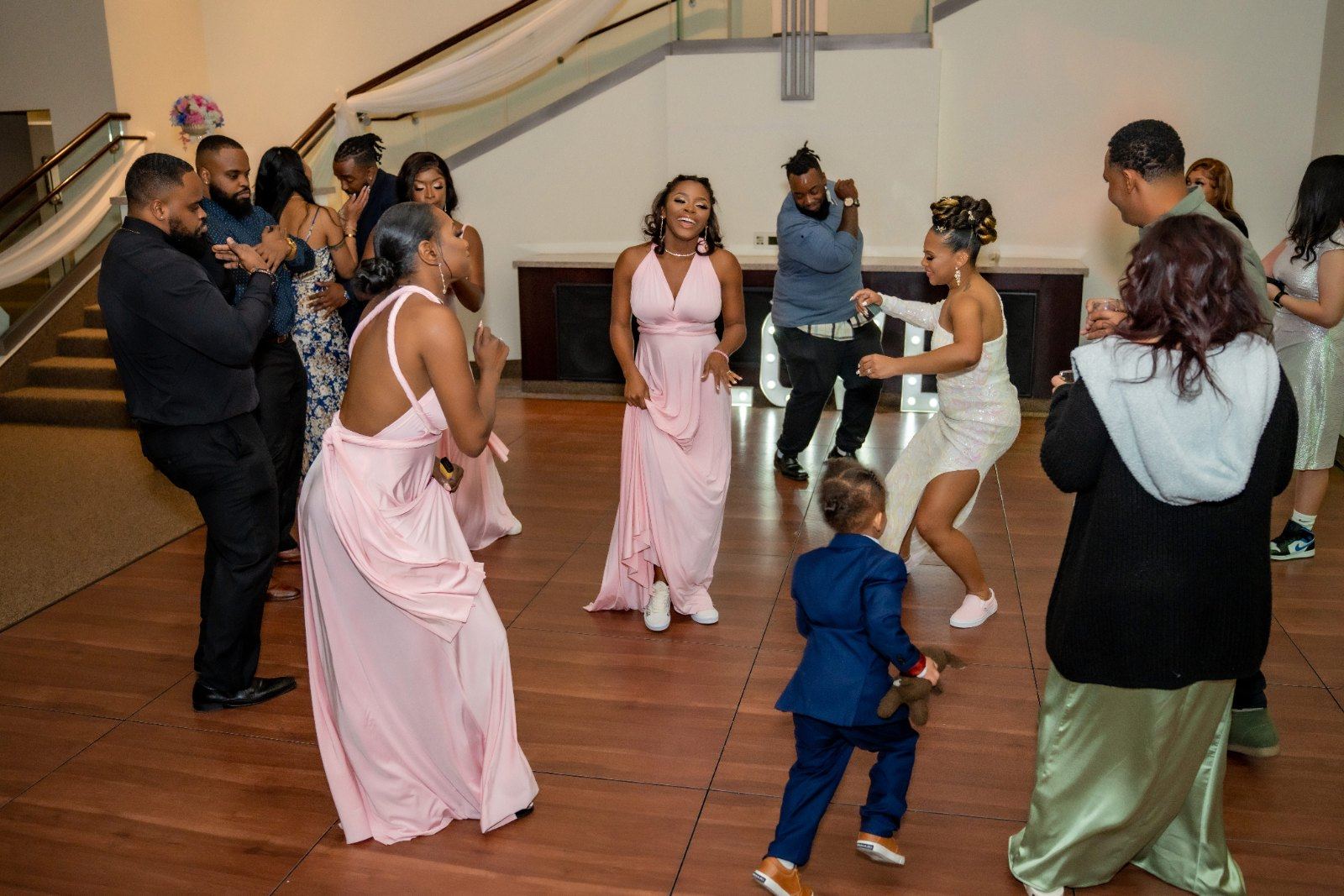 Las Vegas wedding photography — bridesmaids dancing under the lit LOVE sign