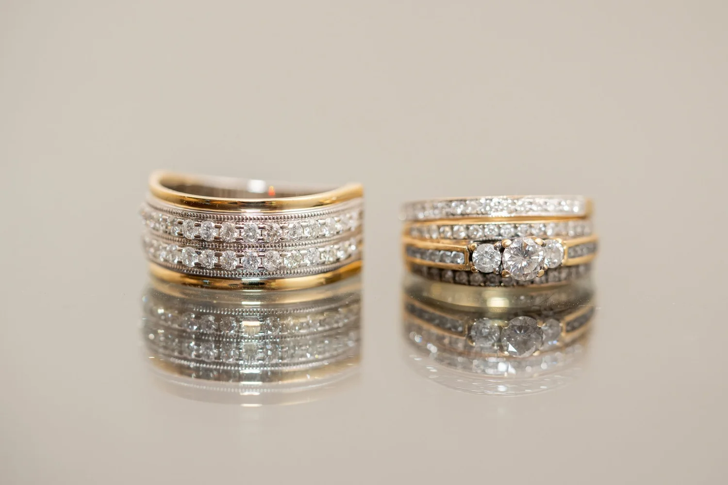 Las Vegas wedding photography — gold and diamond rings on a reflective surface