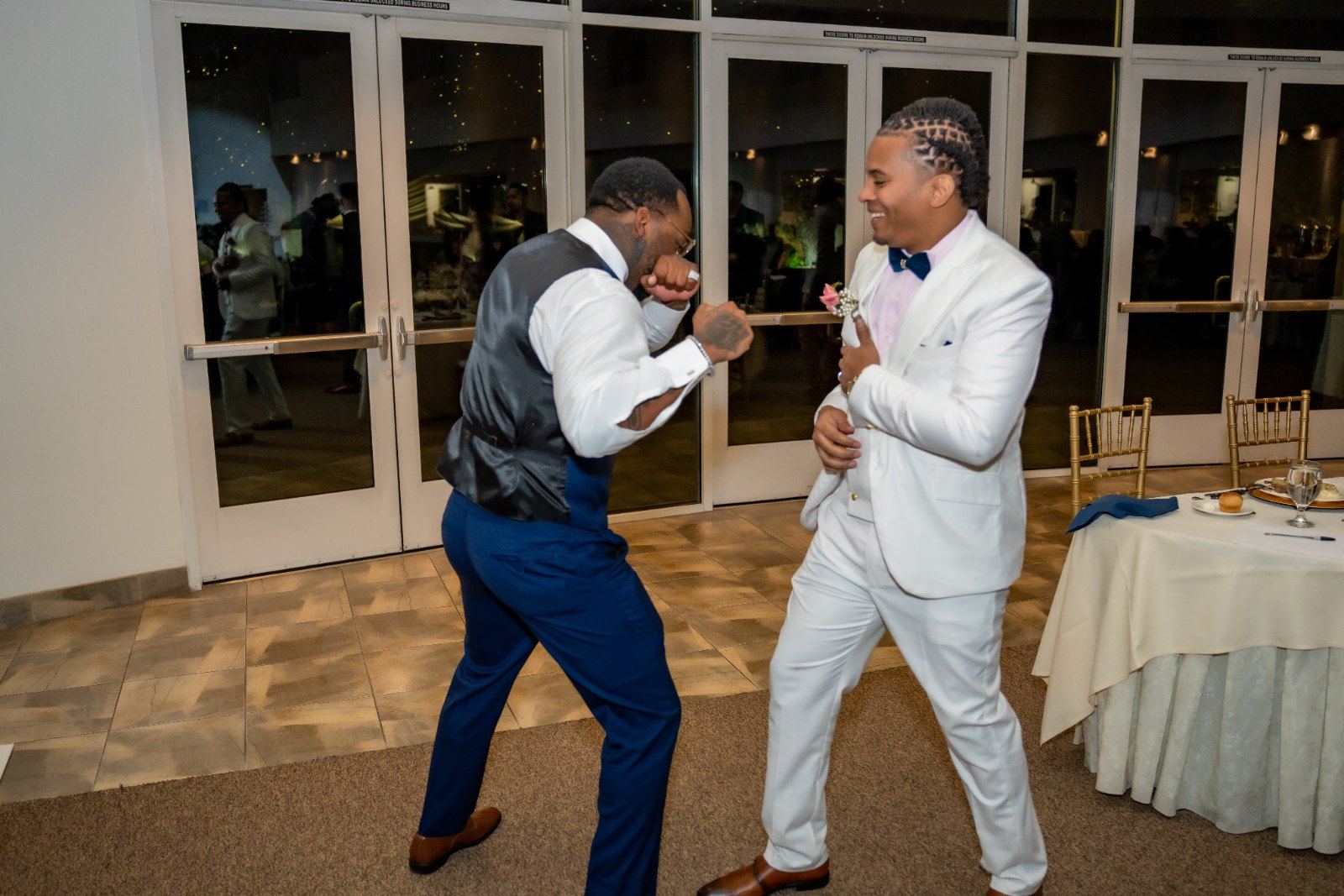 Las Vegas wedding photography — groomsmen play-fighting at the reception entrance