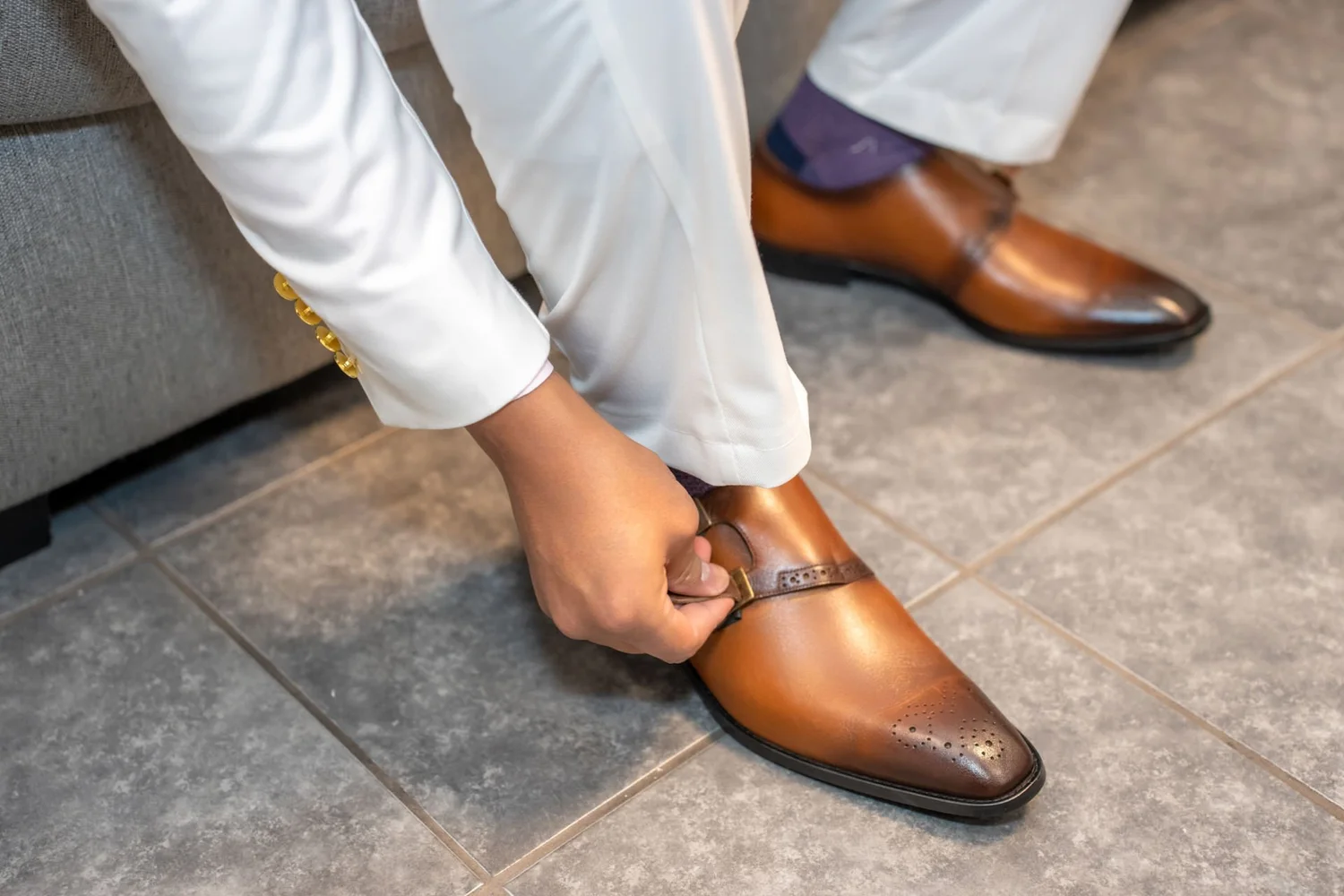 Las Vegas wedding photography — tying brown dress shoes before the ceremony