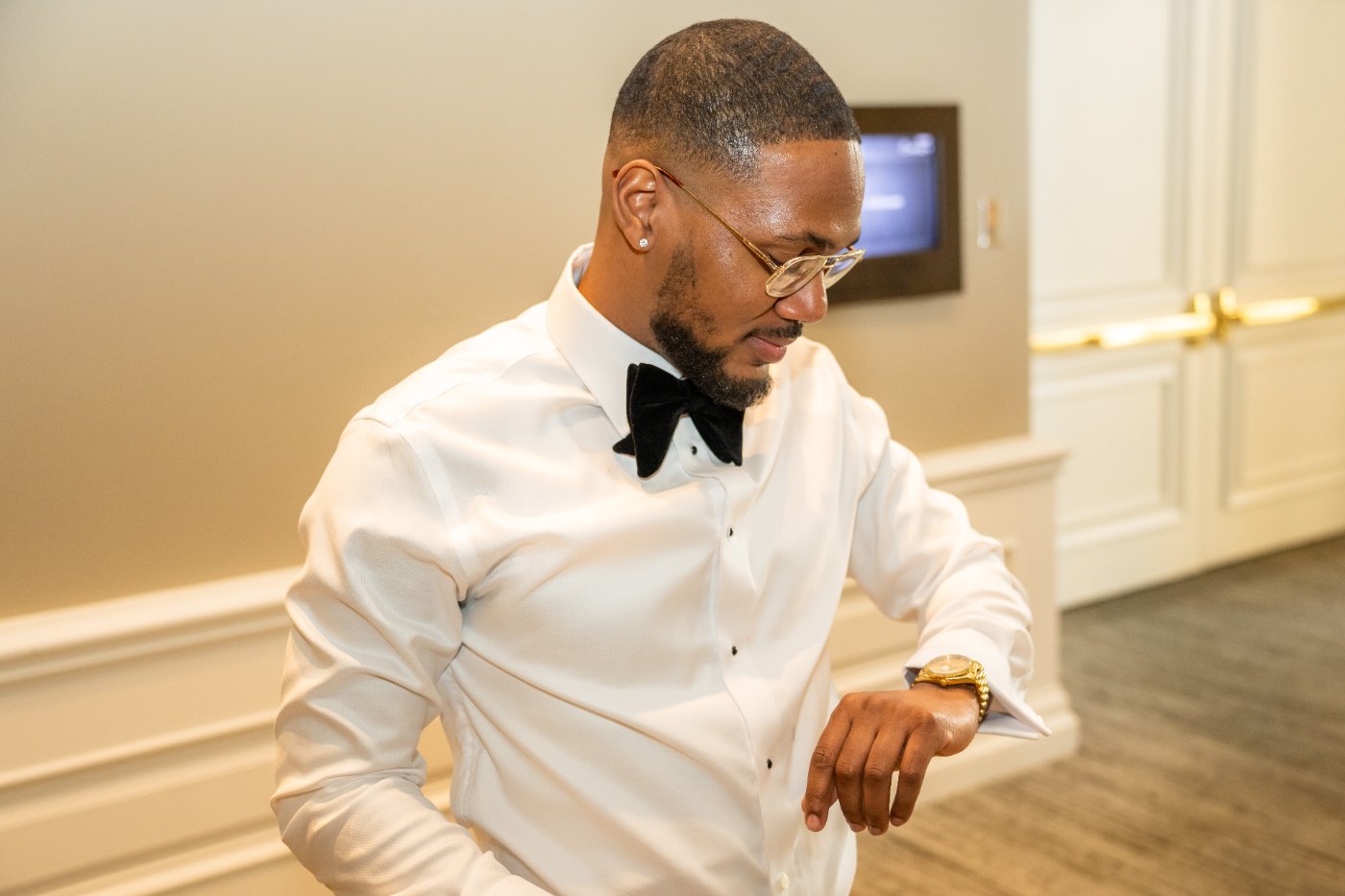 Las Vegas wedding photography — the groom getting ready in a white tuxedo jacket