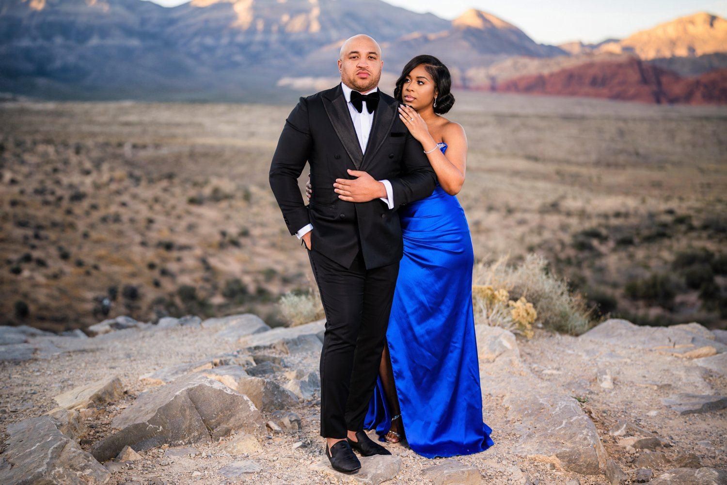Las Vegas wedding photography — an engagement portrait with red rock mountains at golden hour
