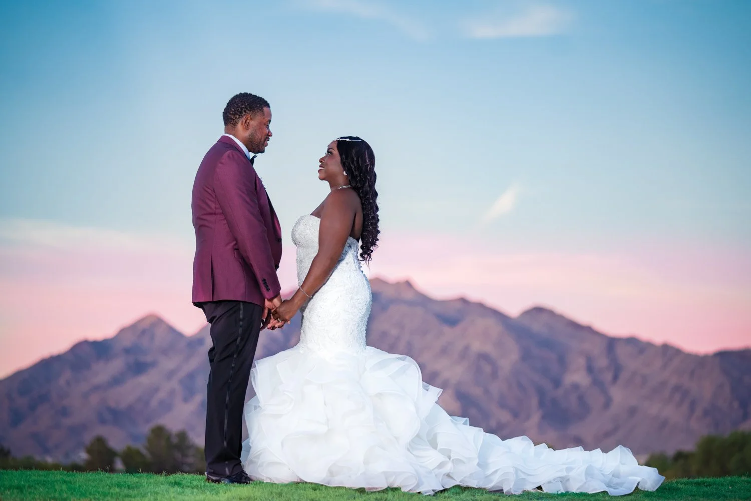 Las Vegas wedding photography — holding hands with a mountain sunset behind