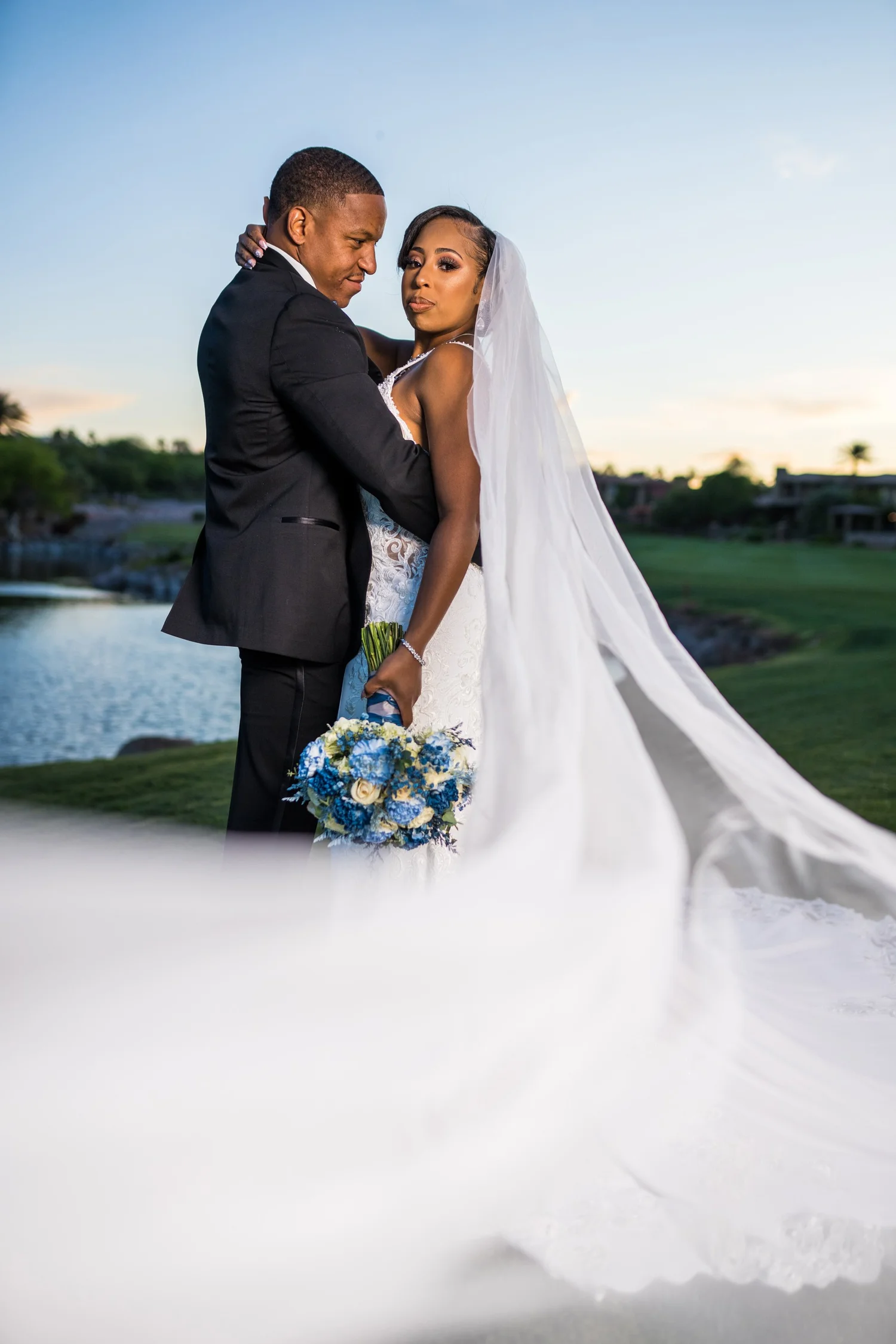 Las Vegas wedding photography — sunset embrace with a blue and white bouquet