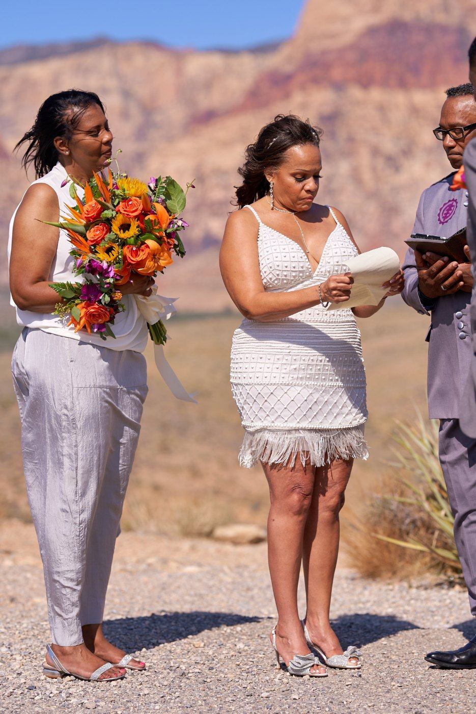 Las Vegas wedding photography — reading vows with a witness standing beside them