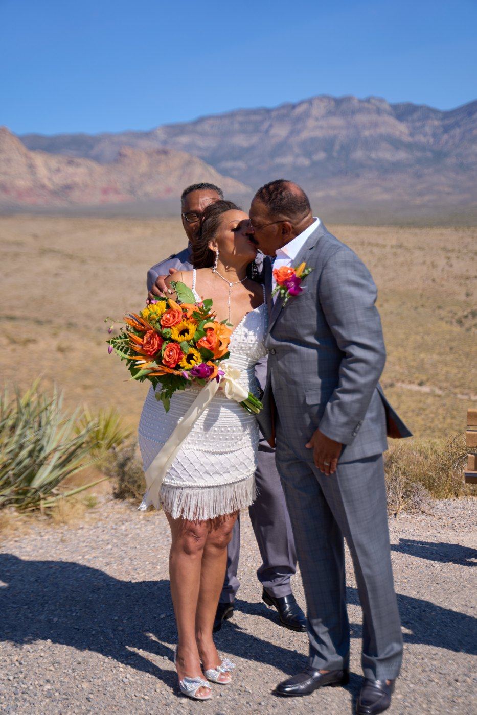 Las Vegas wedding photography — the first kiss with Red Rock Canyon behind
