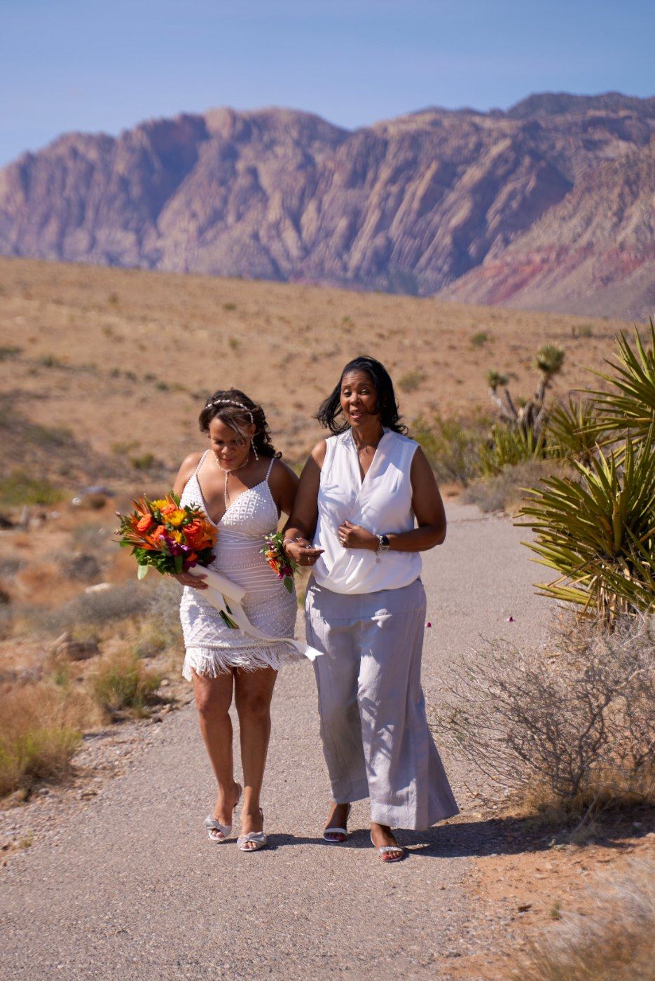 Las Vegas wedding photography — walking the desert path toward the ceremony spot