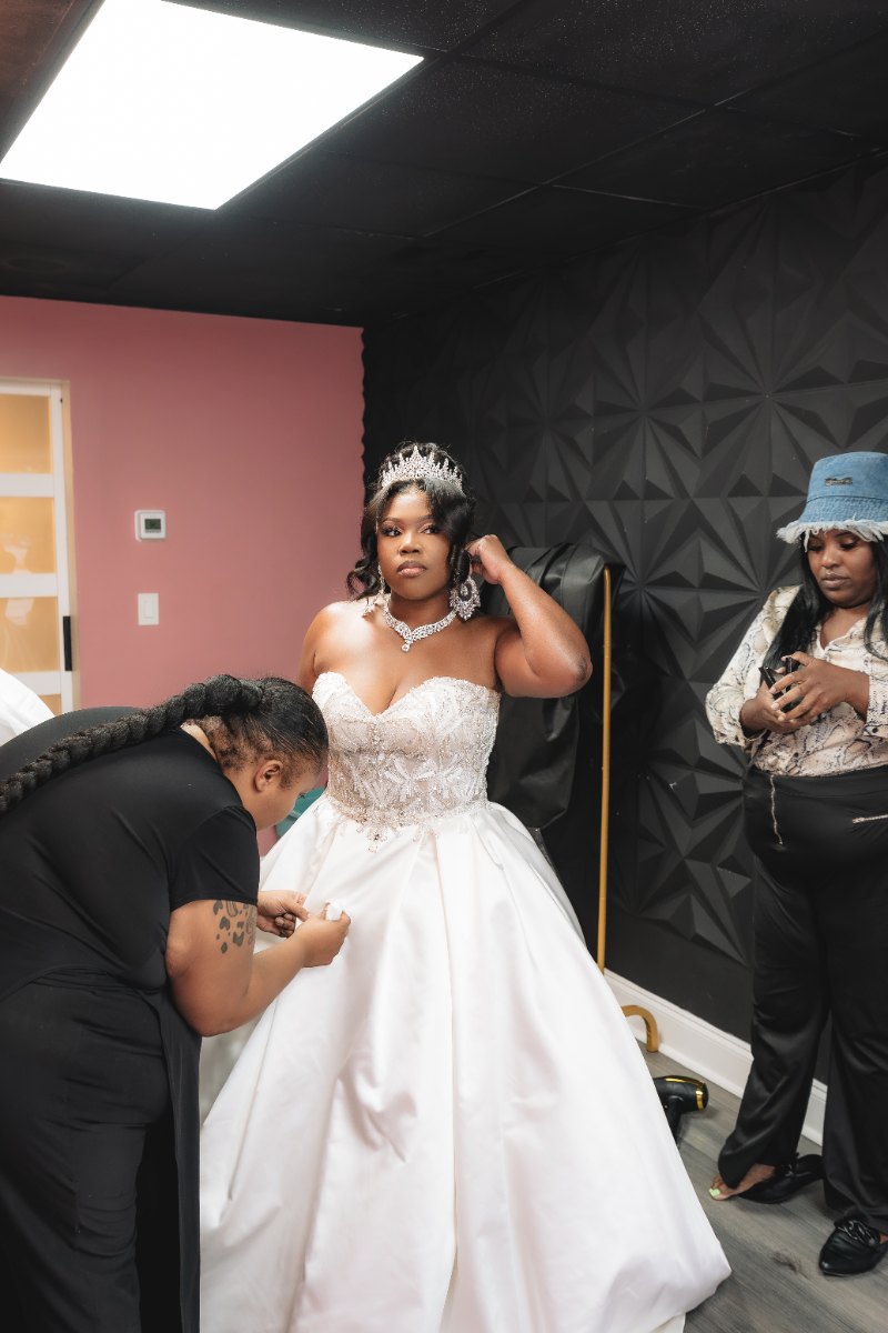 Las Vegas wedding photography — the bride being helped into her ballgown