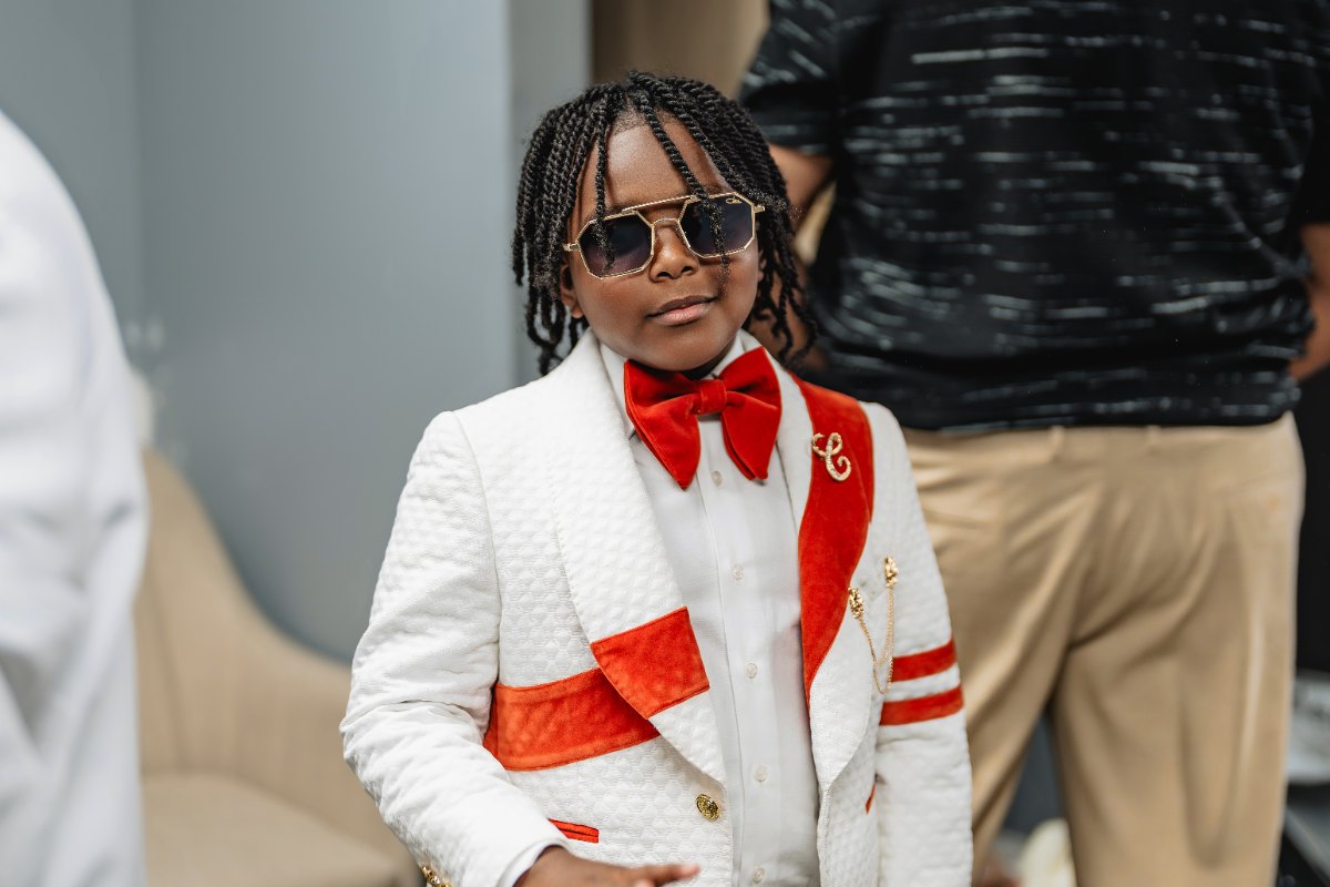 Las Vegas wedding photography — the ring bearer in a white and red suit with sunglasses