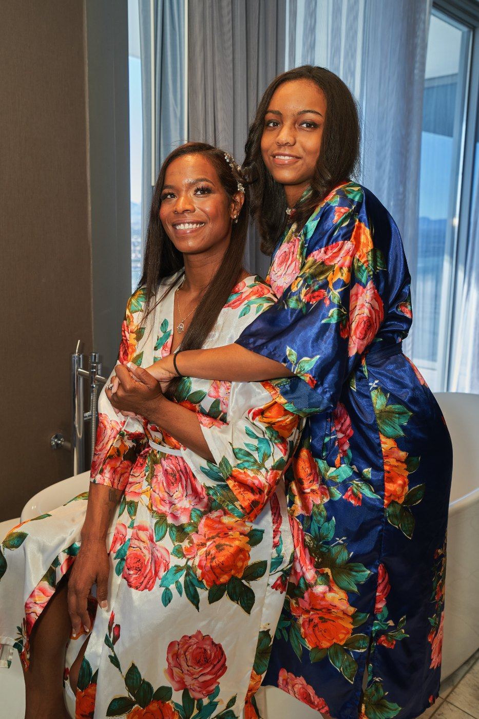 Las Vegas wedding photography — the bride and a friend in robes by the suite window