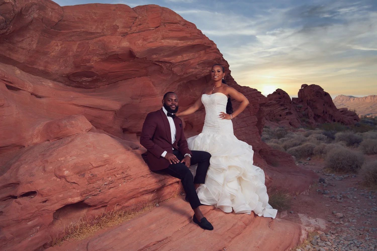Las Vegas wedding photography — seated together on red rock at sunset