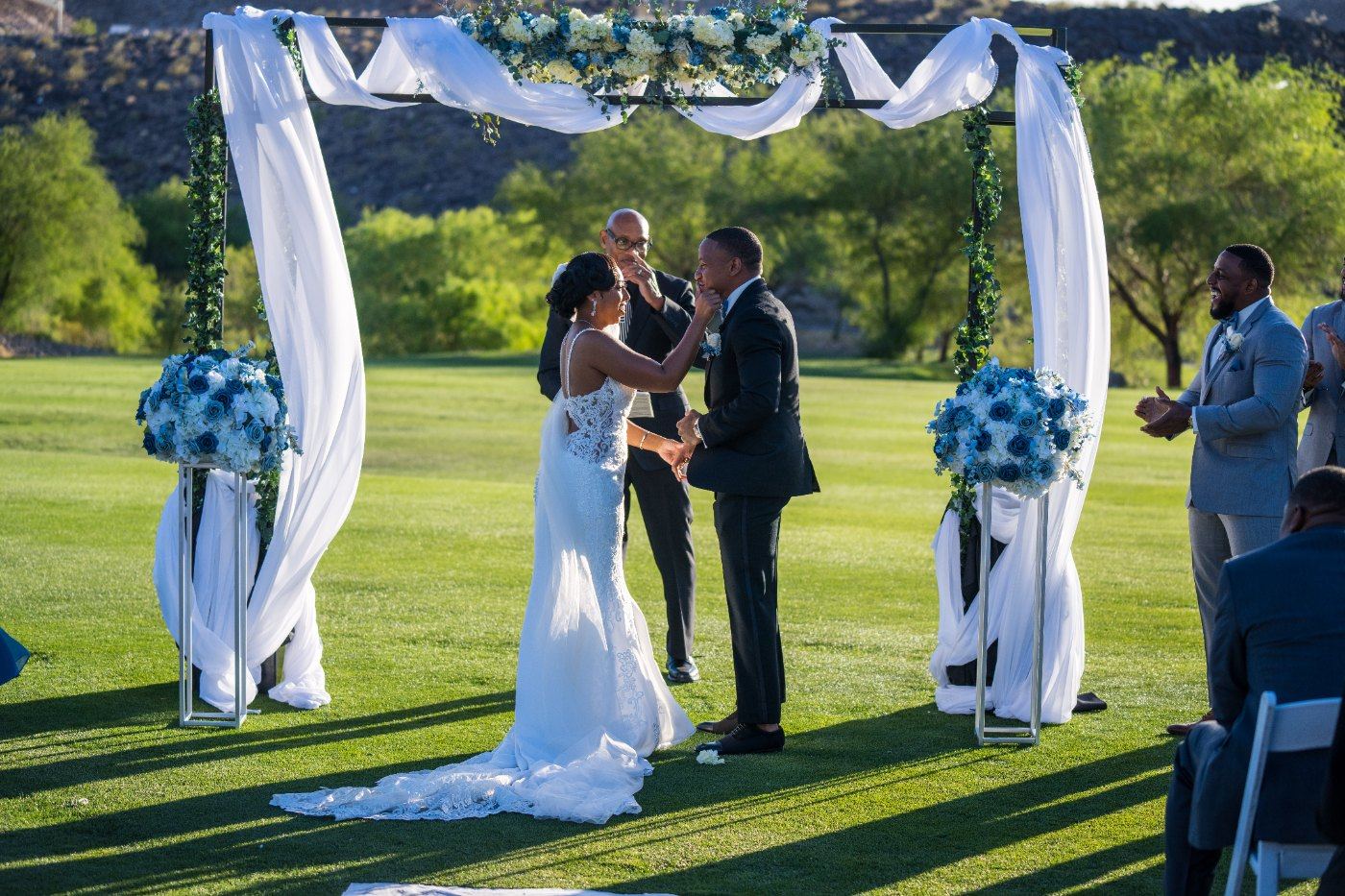 Las Vegas wedding photography — the bride at the altar under the draped floral arch