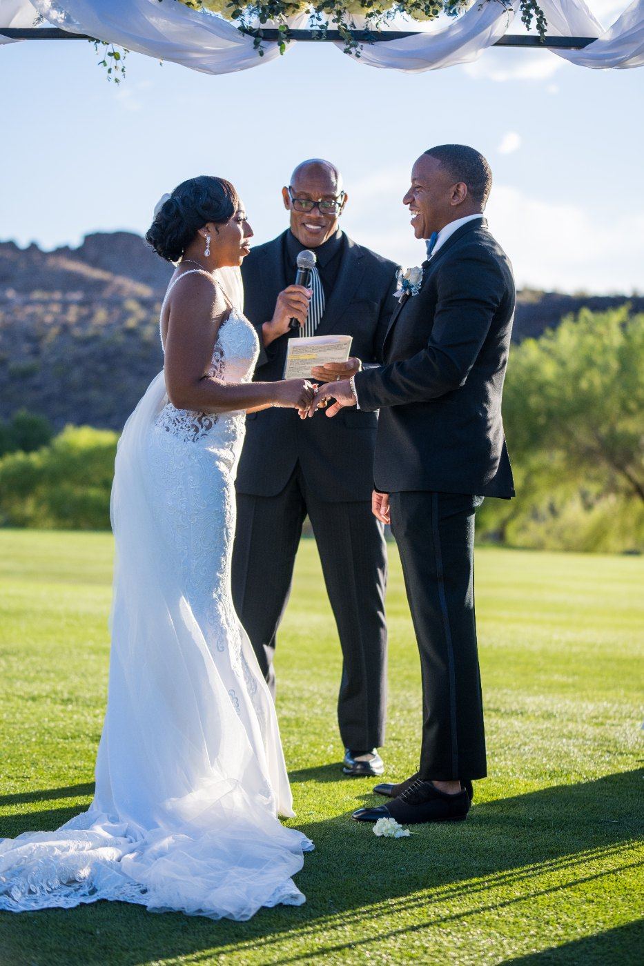 Las Vegas wedding photography — exchanging vows with the officiant on the fairway