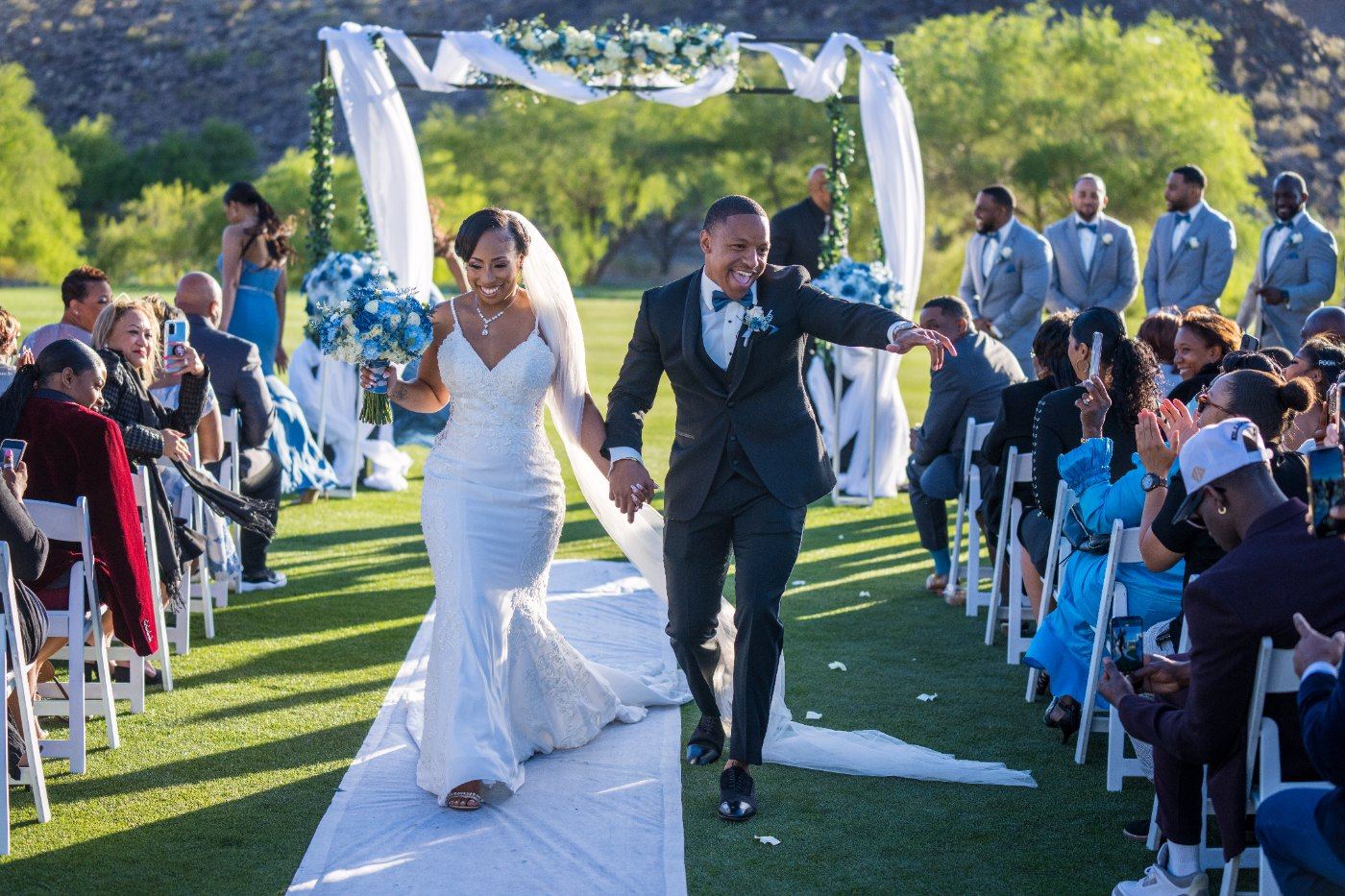Las Vegas wedding photography — the recessional back up the aisle past cheering guests