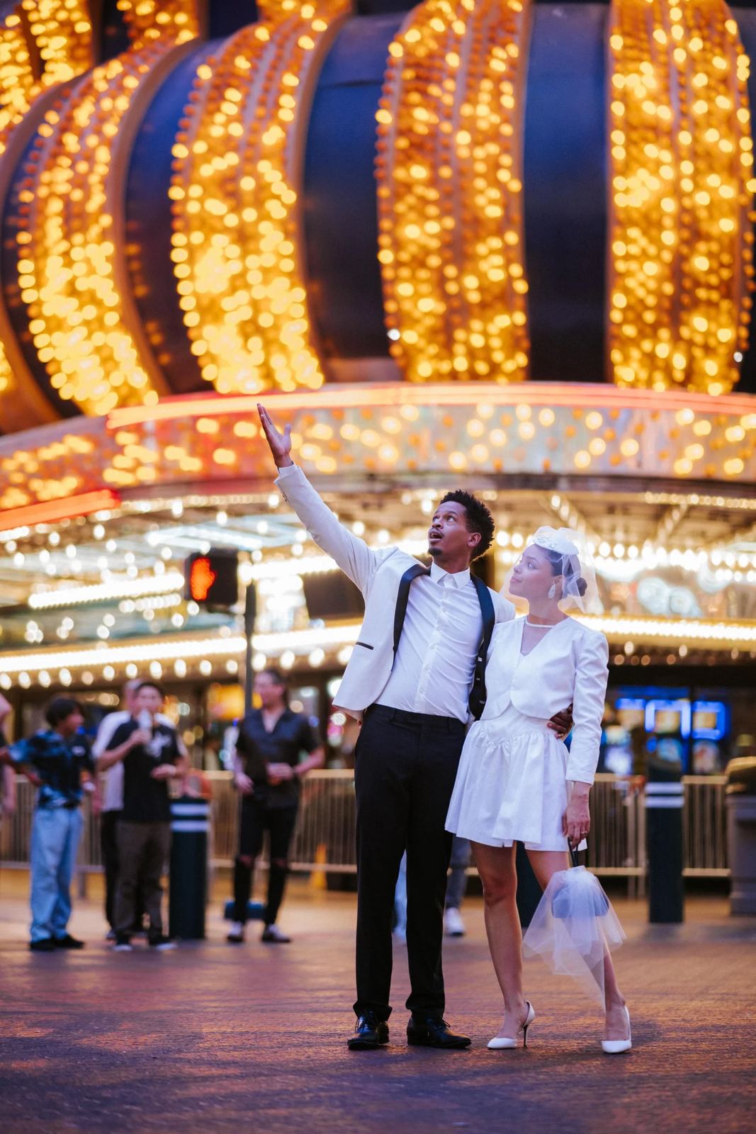 Las Vegas wedding photography — couple in front of a lit amusement park ride at night