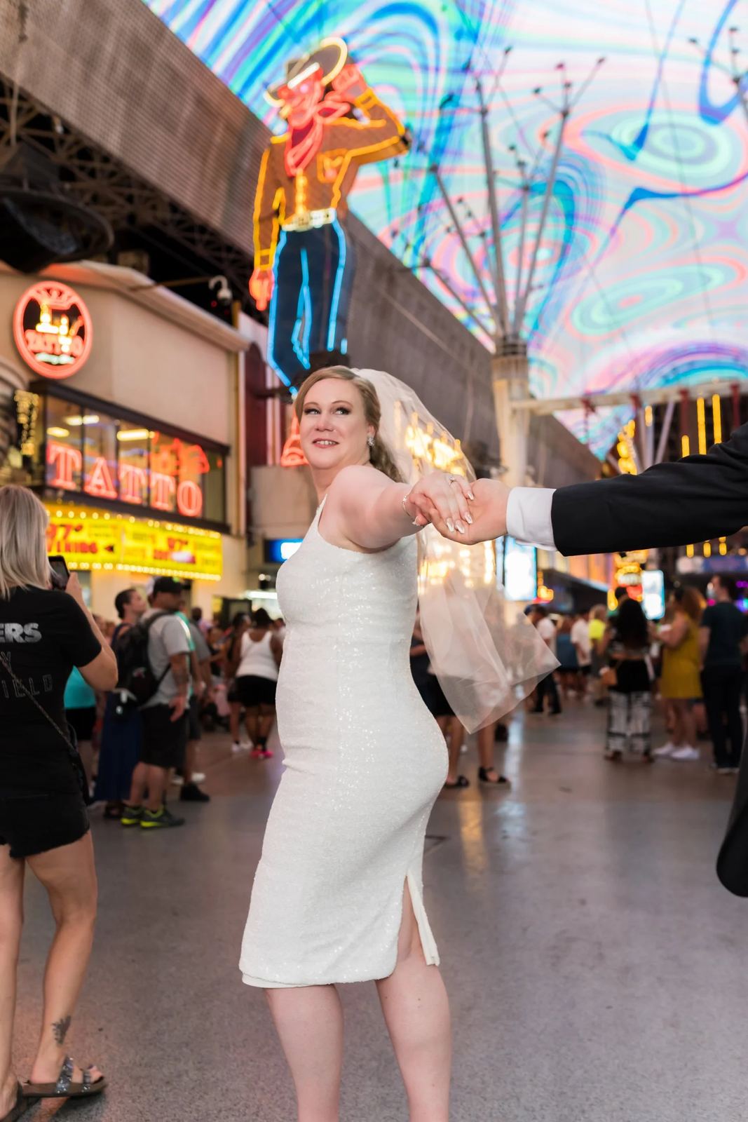 Las Vegas wedding photography — holding hands at a fair under neon lights