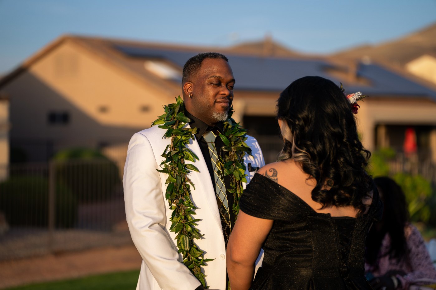 Las Vegas wedding photography — the couple in leis seeing each other on the green