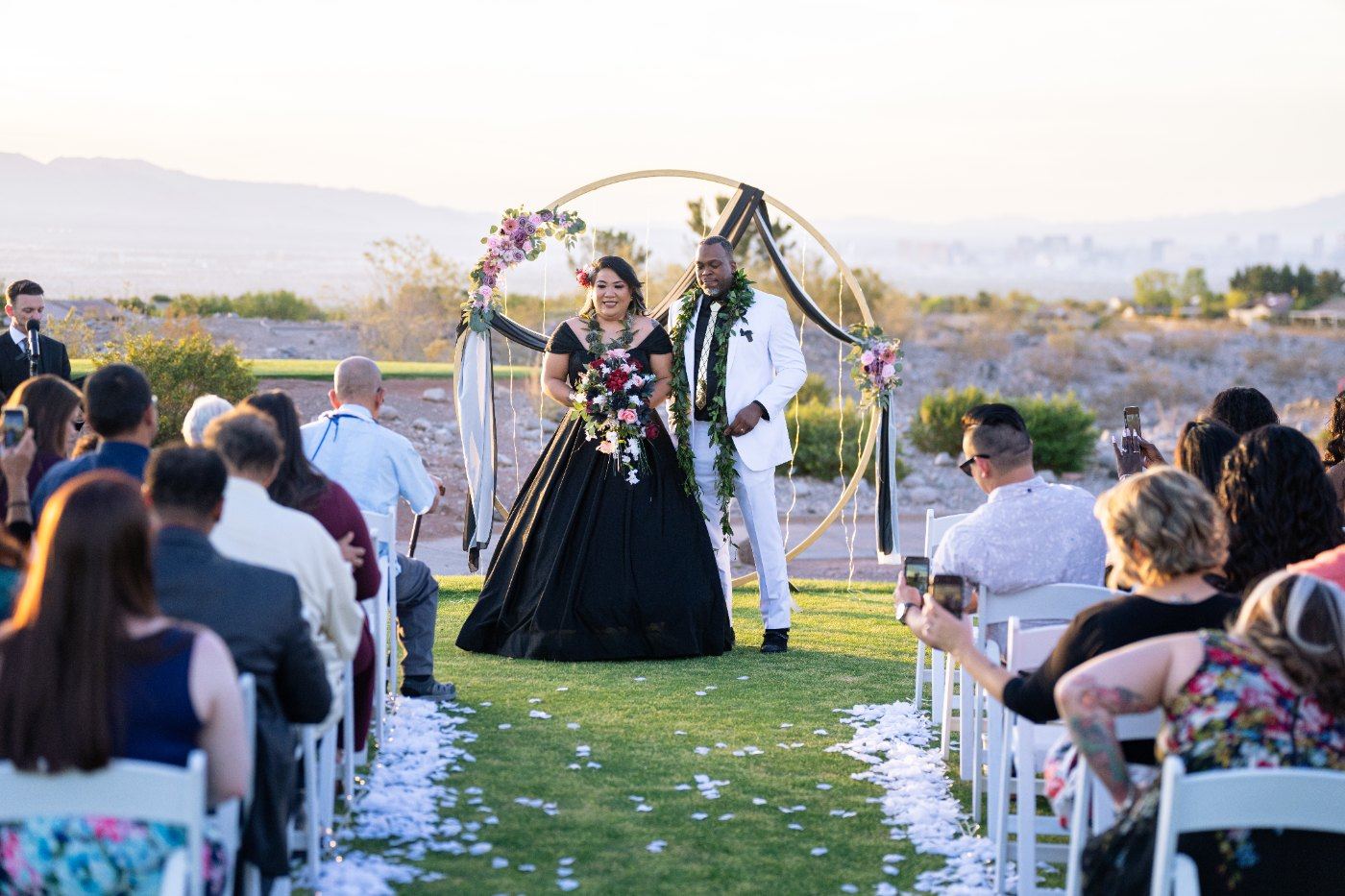 Las Vegas wedding photography — the floral arch ceremony with guests seated on the fairway