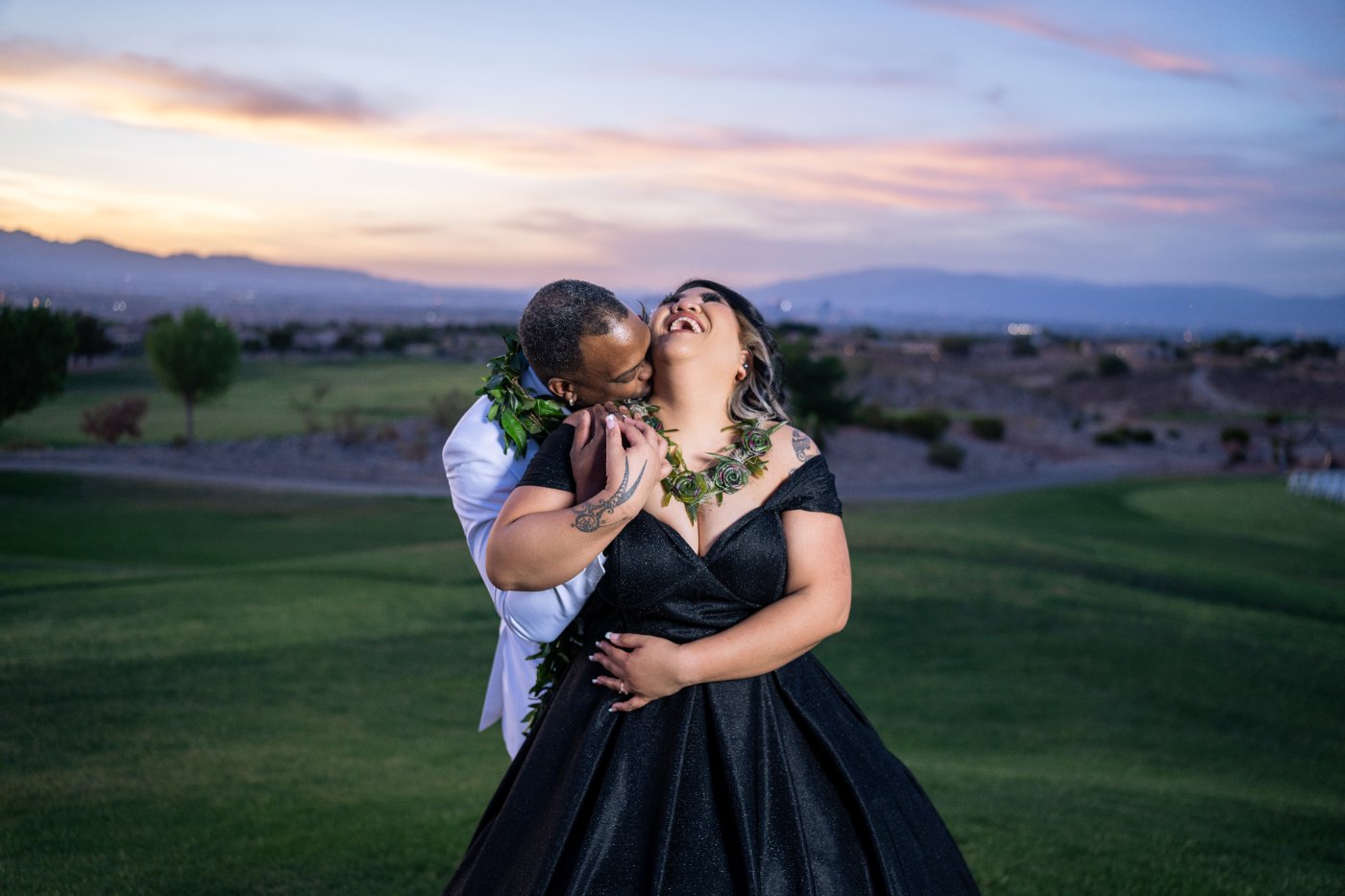 Las Vegas wedding photography — the couple laughing together under a pink desert sky