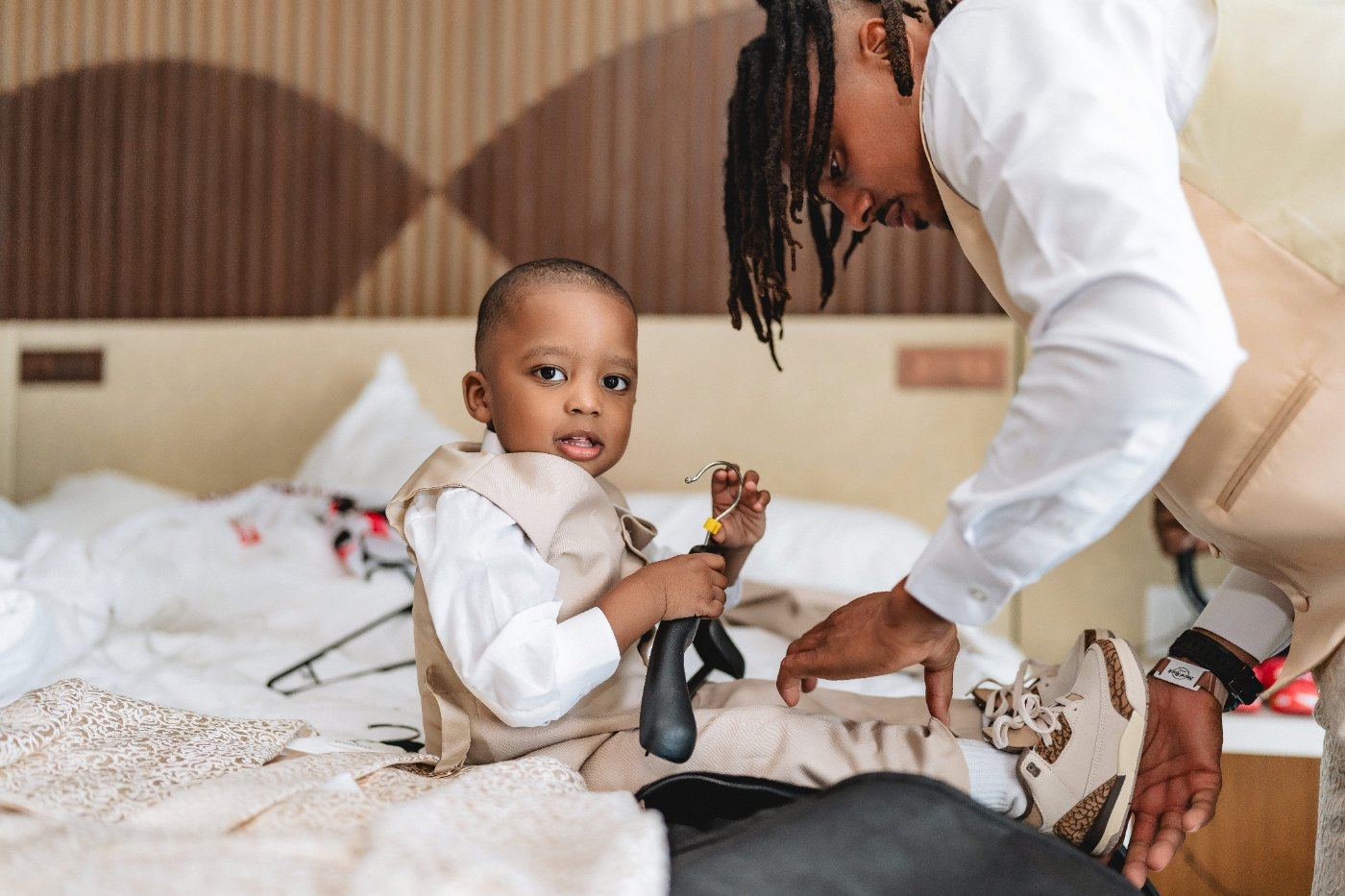 Las Vegas wedding photography — getting their son dressed for the day on the bed