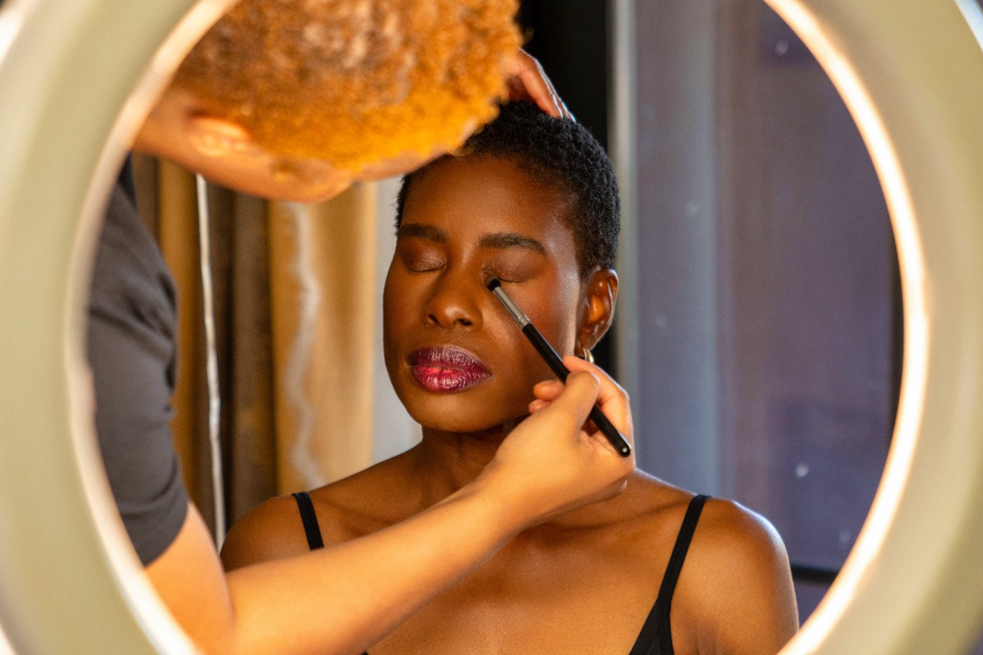 Las Vegas wedding photography — bride having her makeup finished in a ring light