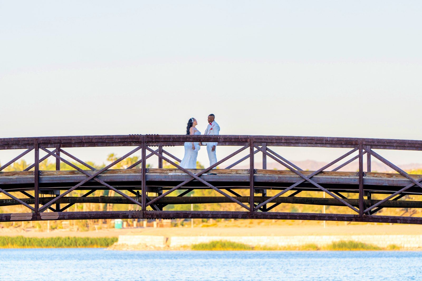 Las Vegas wedding photography — the couple on the footbridge over the water at sunset
