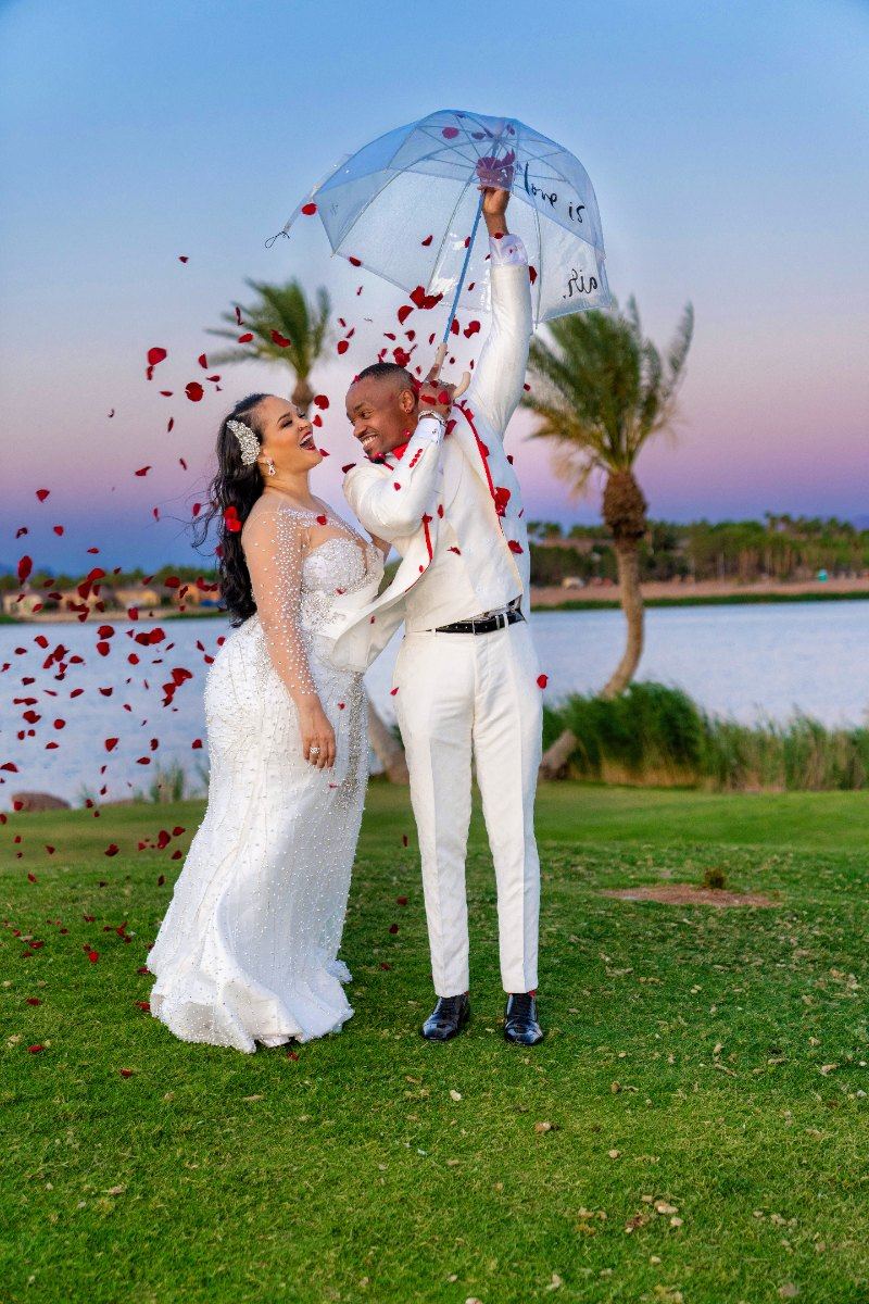 Las Vegas wedding photography — the petal toss under an umbrella from a side angle