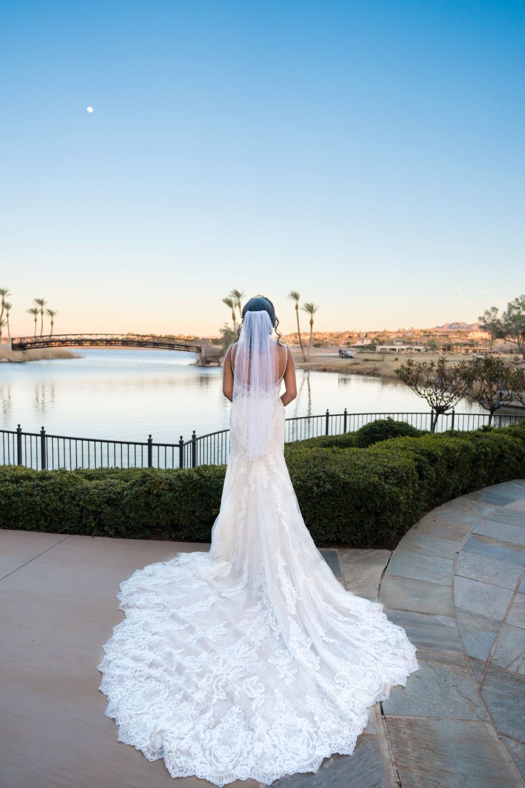 Las Vegas wedding photography — bride with her train spread at dusk by the lake