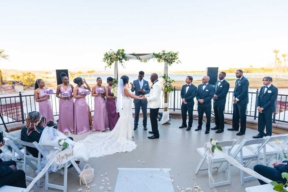 Las Vegas wedding photography — the ceremony overlooking the lake with bridesmaids in mauve