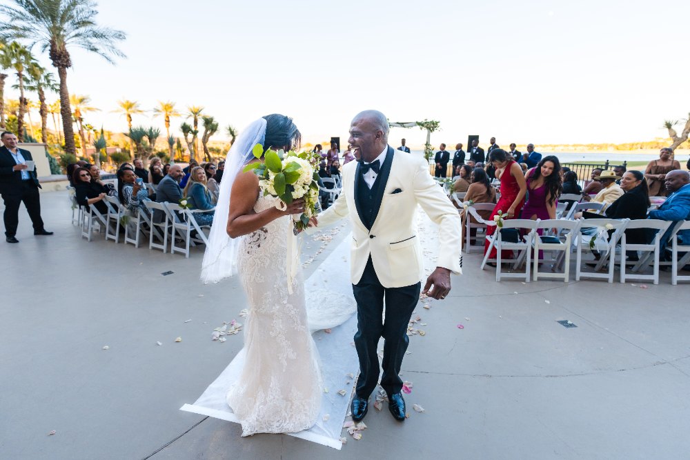 Las Vegas wedding photography — the bride’s father walking her down the aisle, all smiles