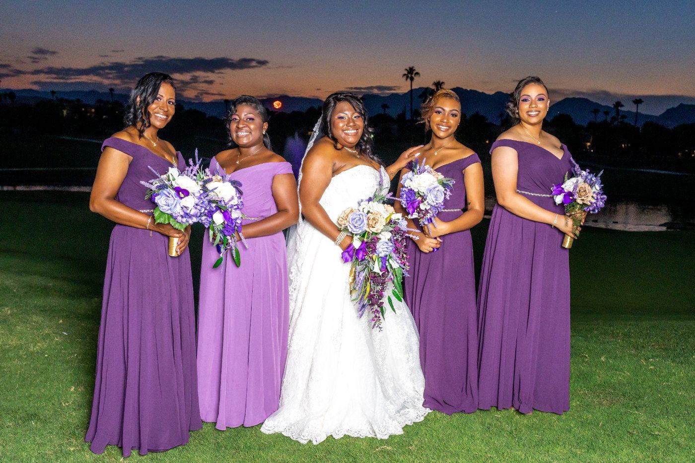 Las Vegas wedding photography — the bridesmaids in purple on the lawn at dusk