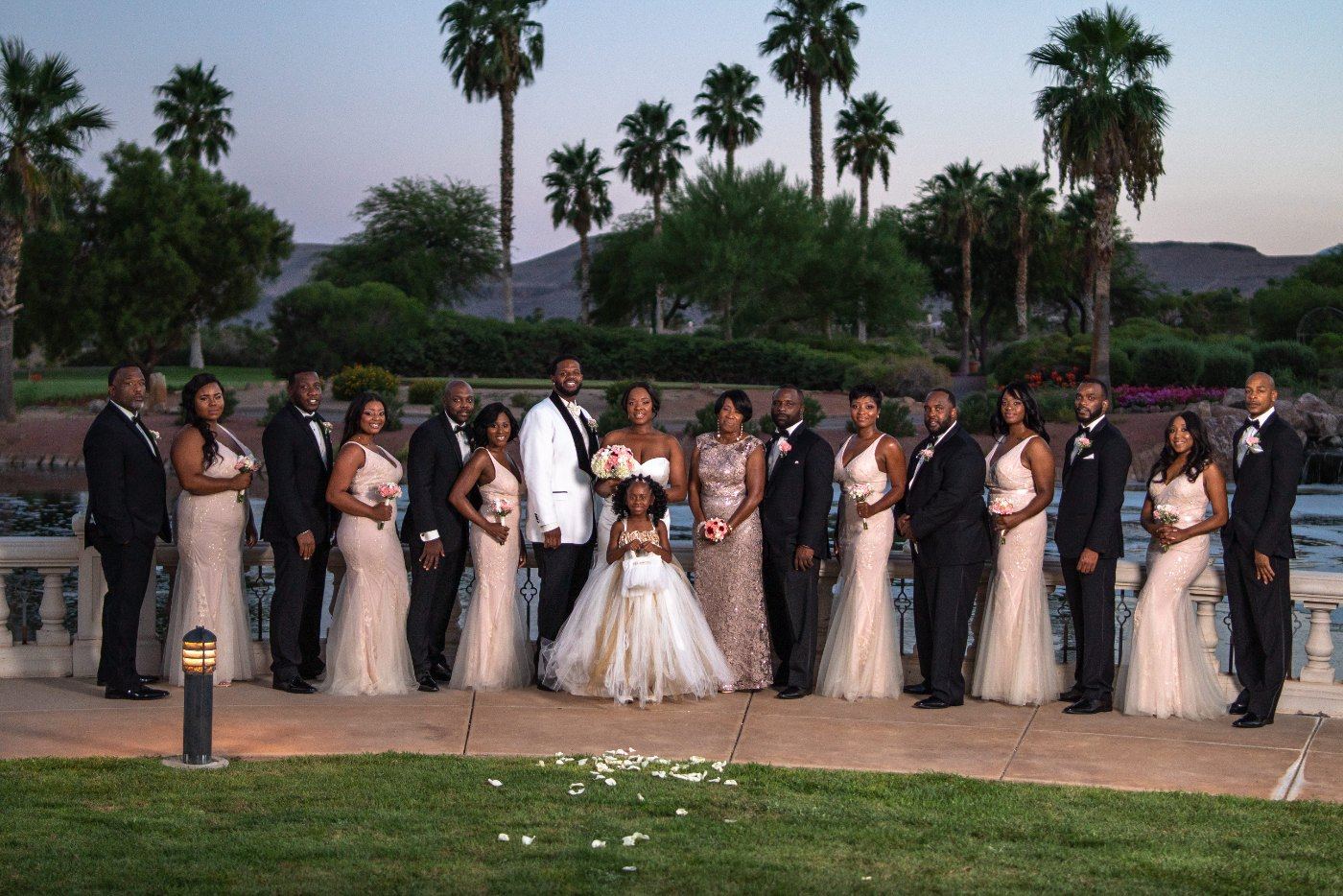 Las Vegas wedding photography — the wedding party lined up at sunset under the palms