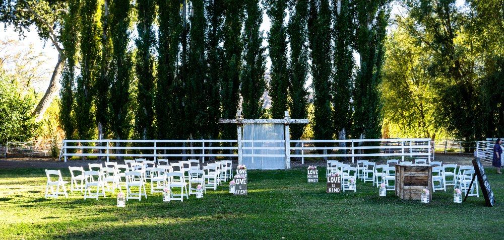 Las Vegas wedding photography — the ceremony arch set up among tall trees at the ranch