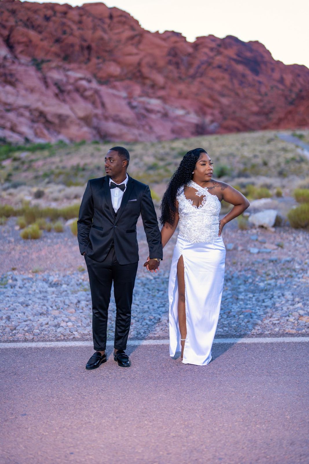 Las Vegas wedding photography — the couple holding hands on the road through Red Rock
