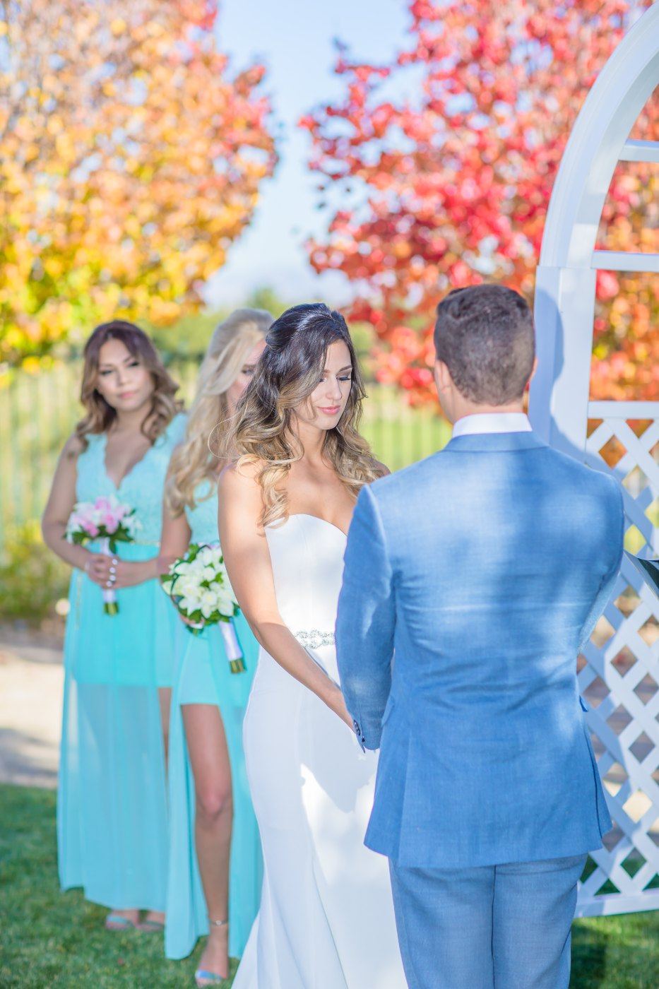 Las Vegas wedding photography — the bride at the arch surrounded by autumn color