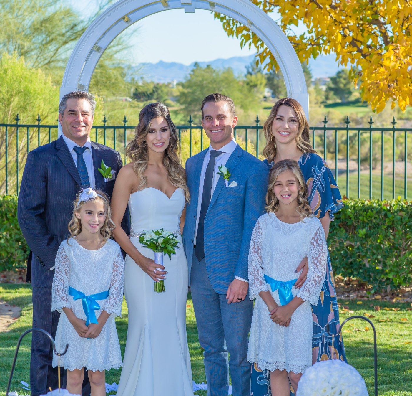 Las Vegas wedding photography — the family gathered under the arch in autumn light