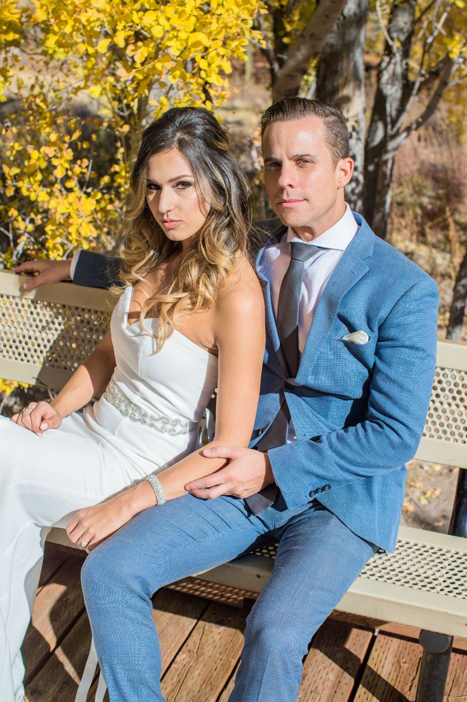 Las Vegas wedding photography — the couple seated on a bench in autumn light