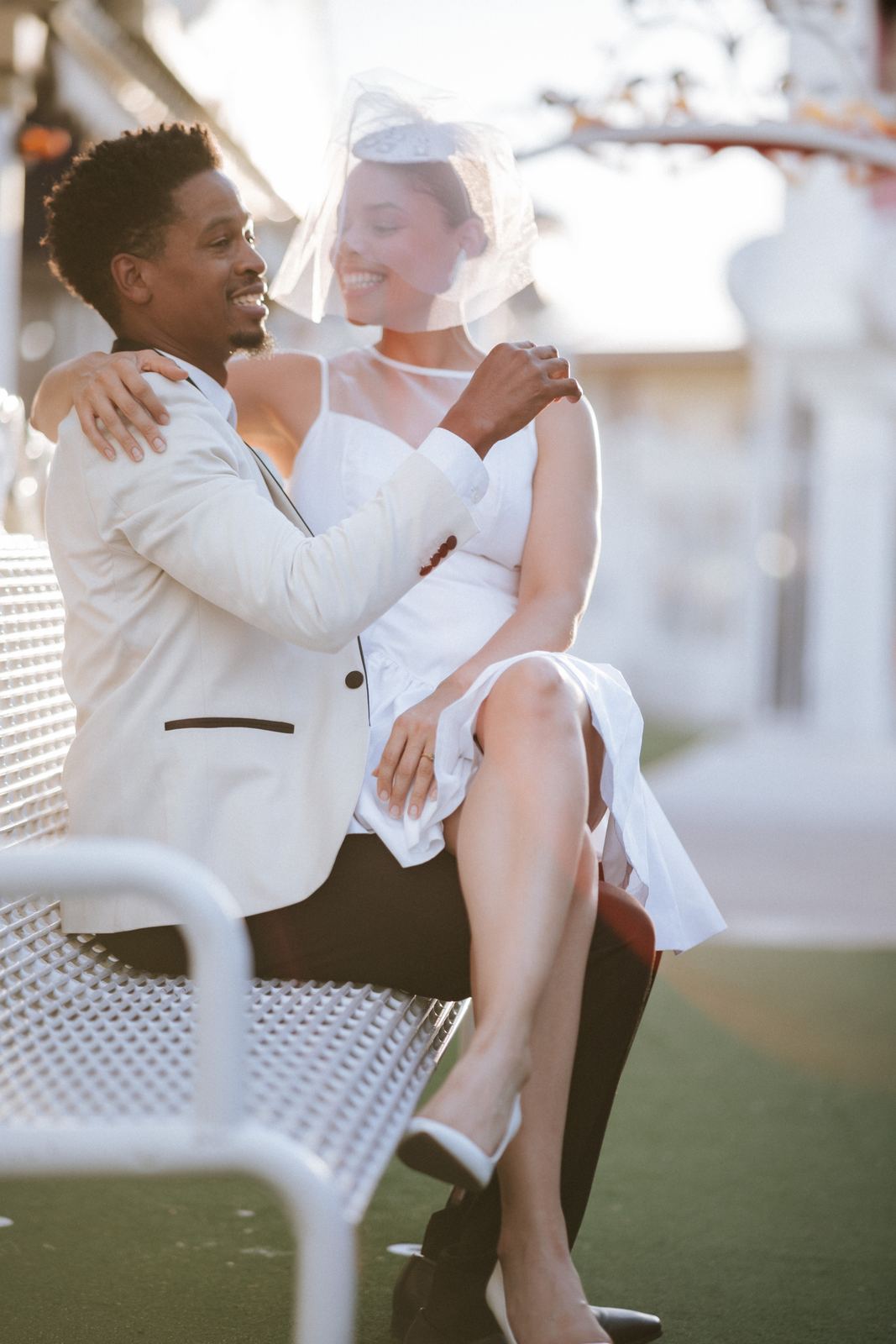 Las Vegas wedding photography — a close embrace on a white iron bench