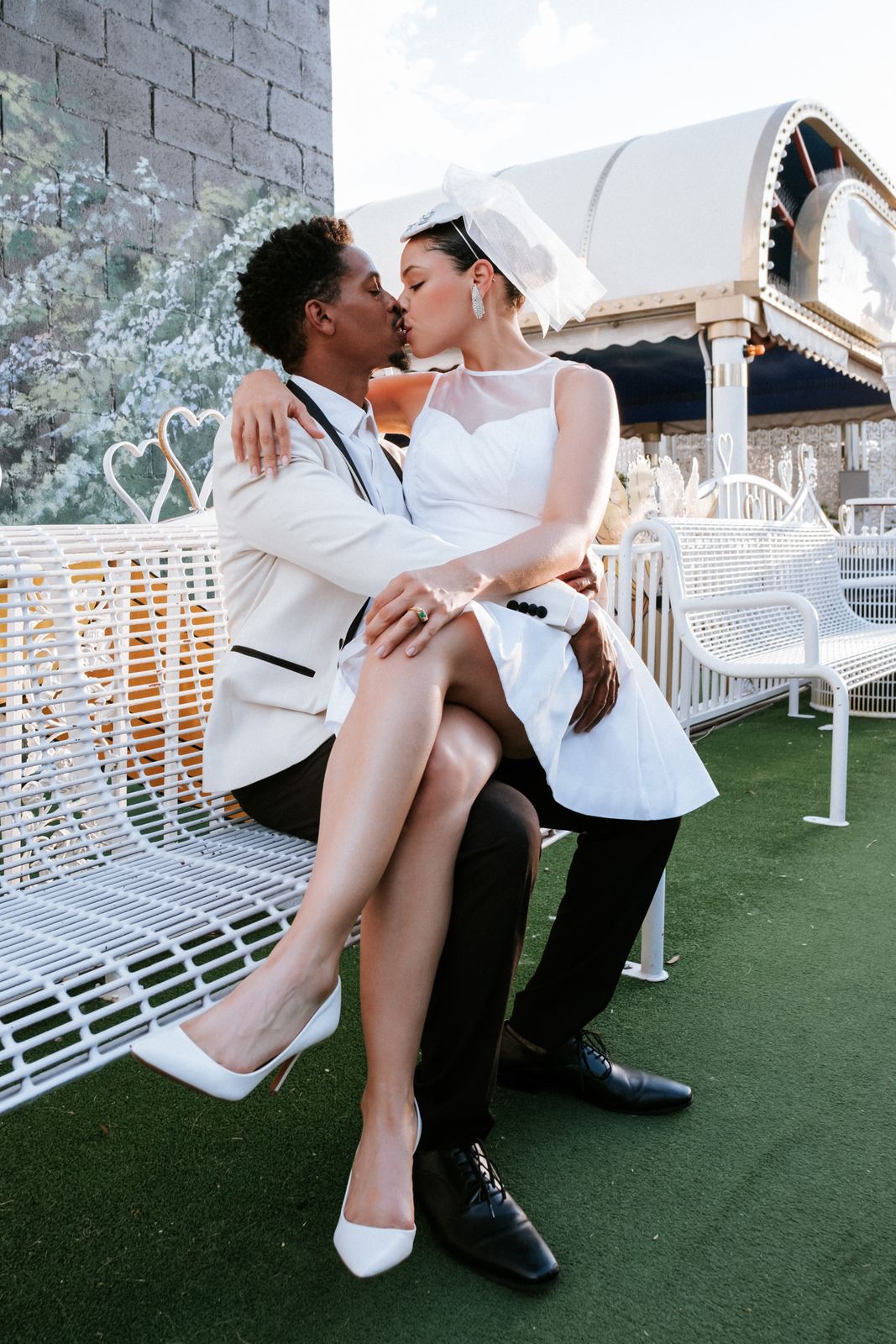 Las Vegas wedding photography — a kiss on the white chapel loveseat