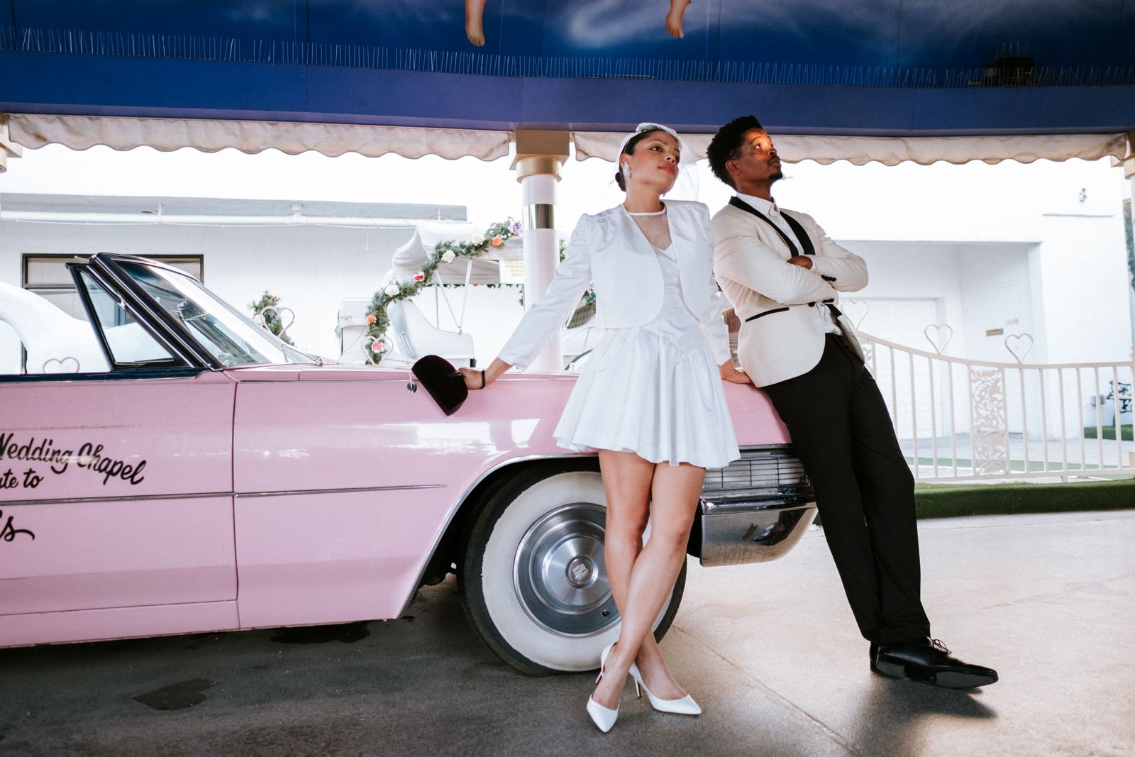 Las Vegas wedding photography — leaning together on a vintage pink Cadillac