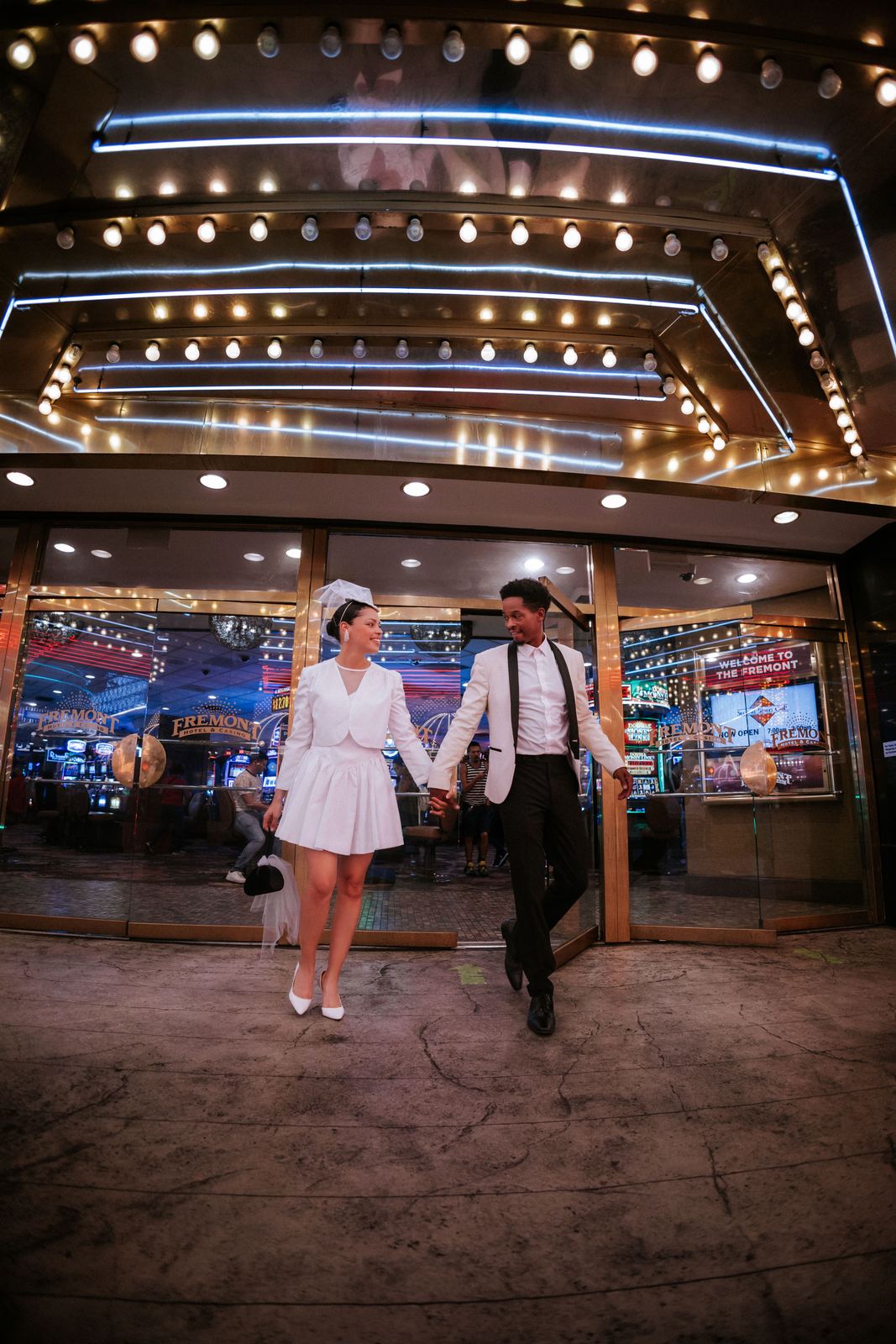 Las Vegas wedding photography — walking hand in hand under the marquee lights