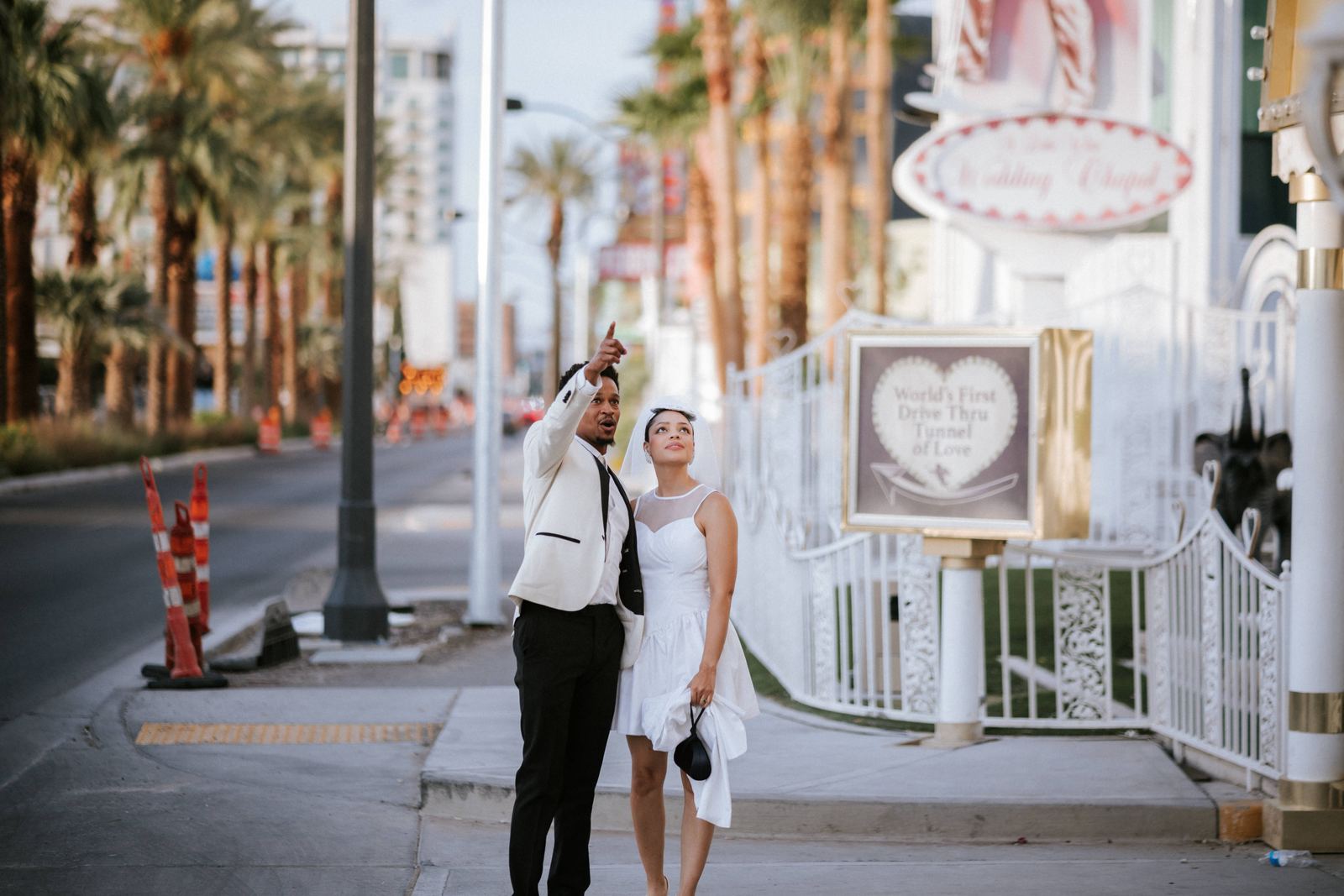 Las Vegas wedding photography — walking hand in hand down a palm-lined street