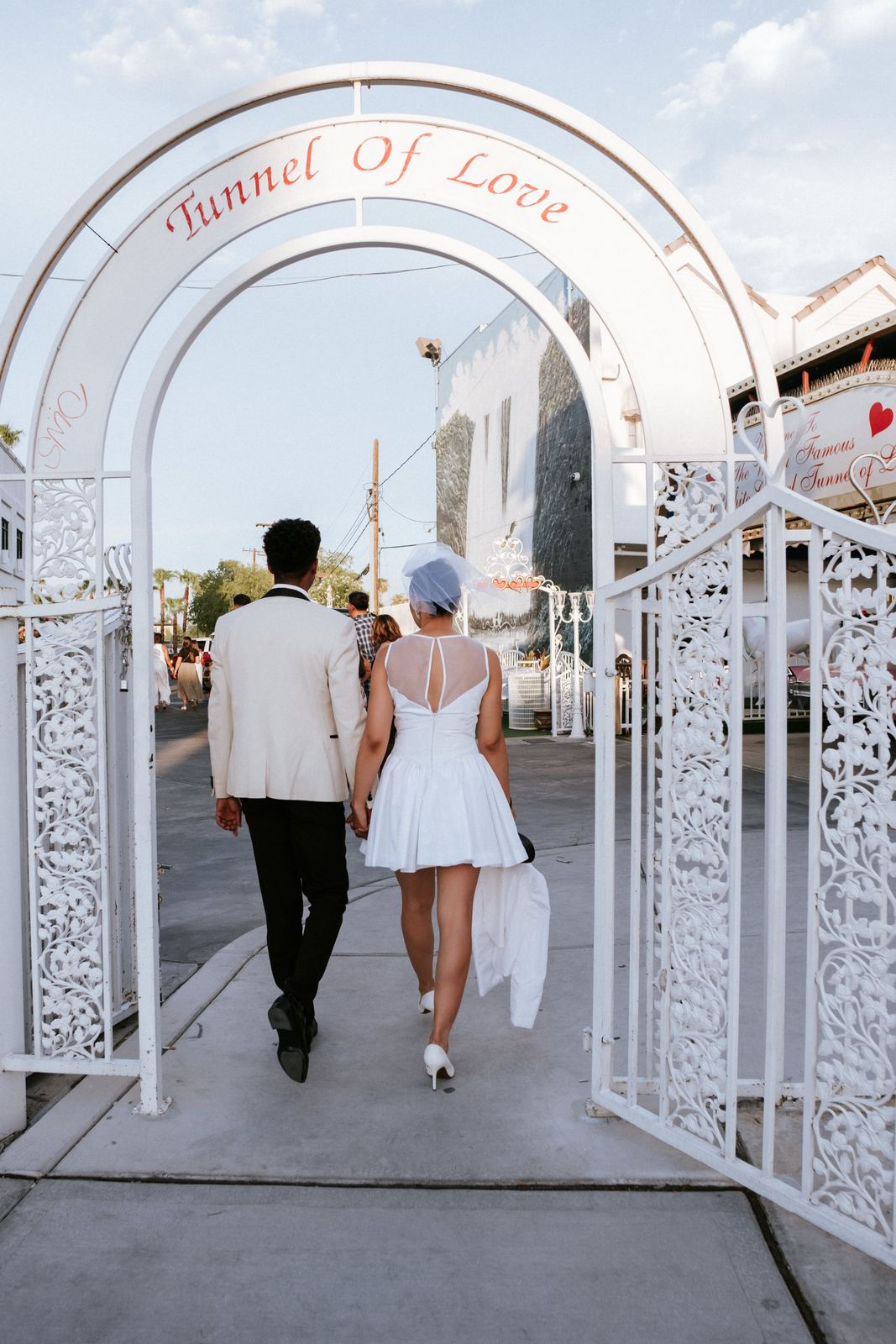 Las Vegas wedding photography — walking through the Tunnel of Love arch