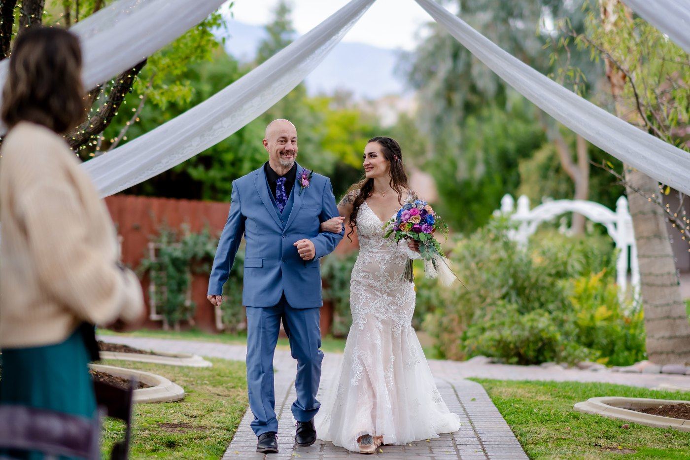 Las Vegas wedding photography — the bride walking down the garden aisle with her father